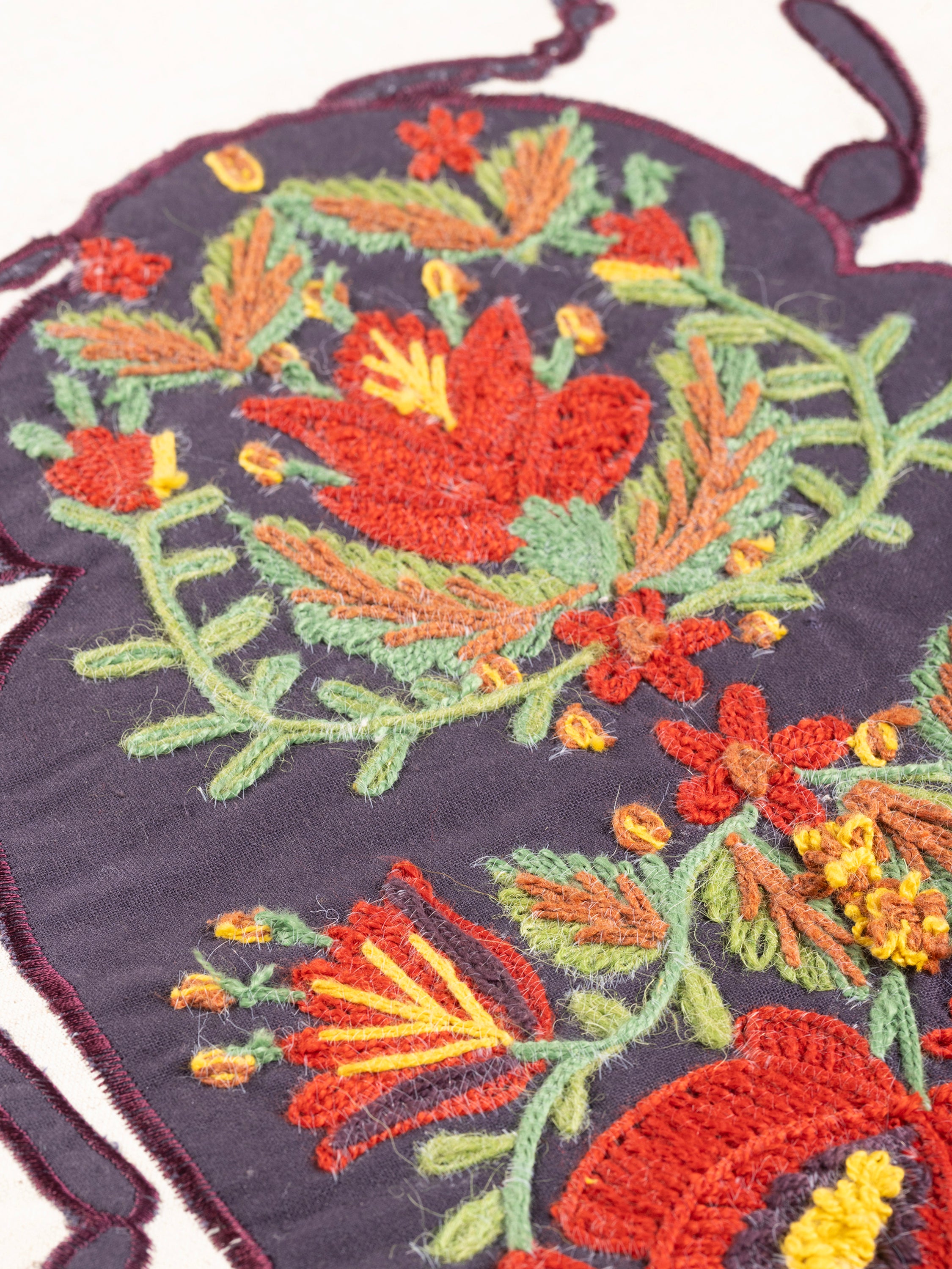 Decorative throw pillow with embroidered beetle motif on soft cotton field — handcrafted design accessory