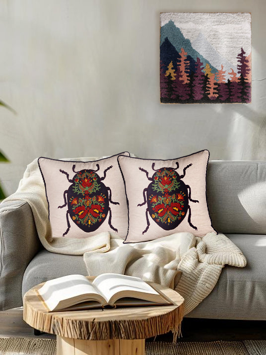 Textured cotton throw pillow featuring embroidered insect and floral motif — timeless artisan home accent