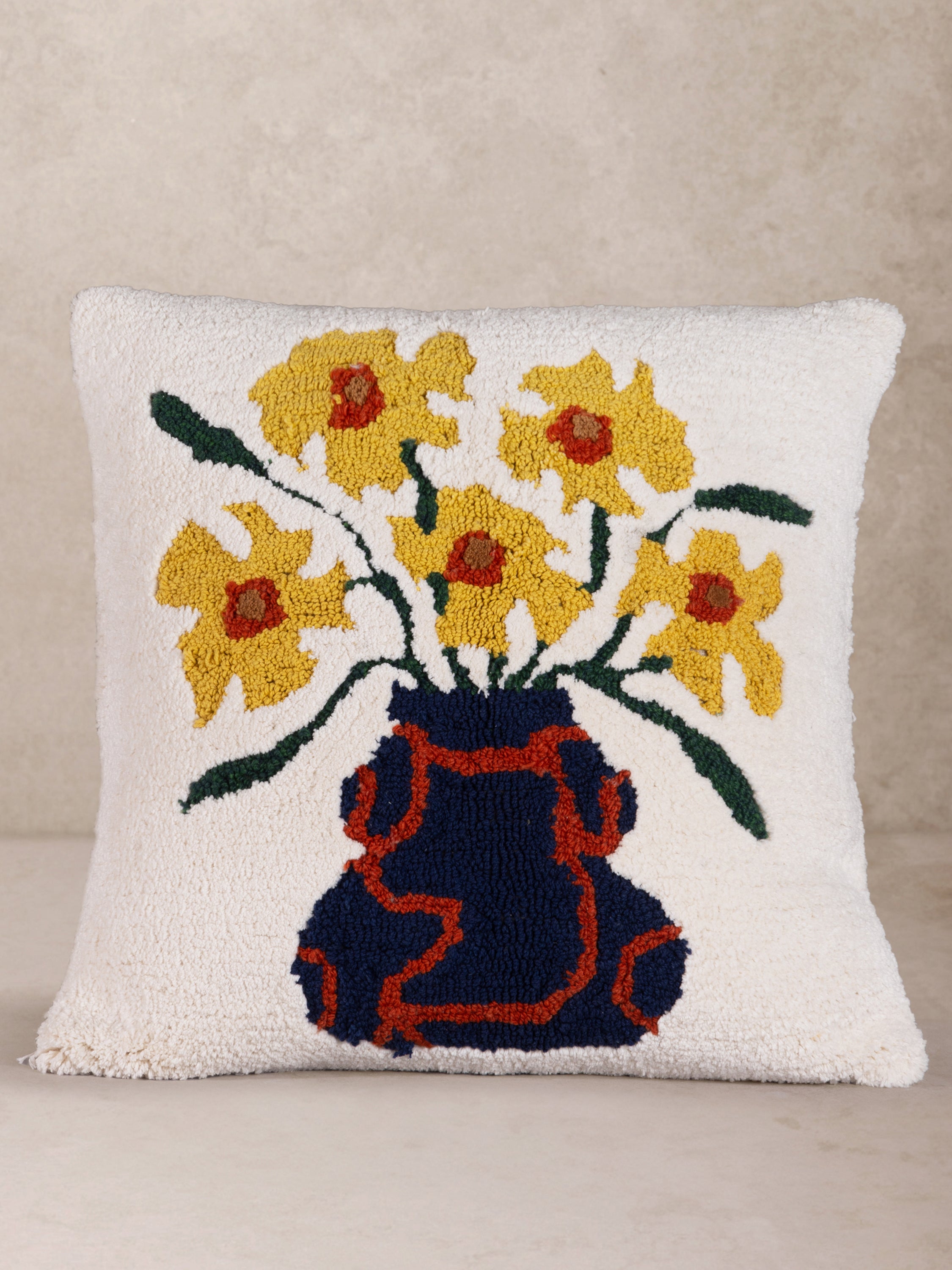 Handcrafted throw pillow in cotton and wool with raised floral motif and rich texture — artisan accent