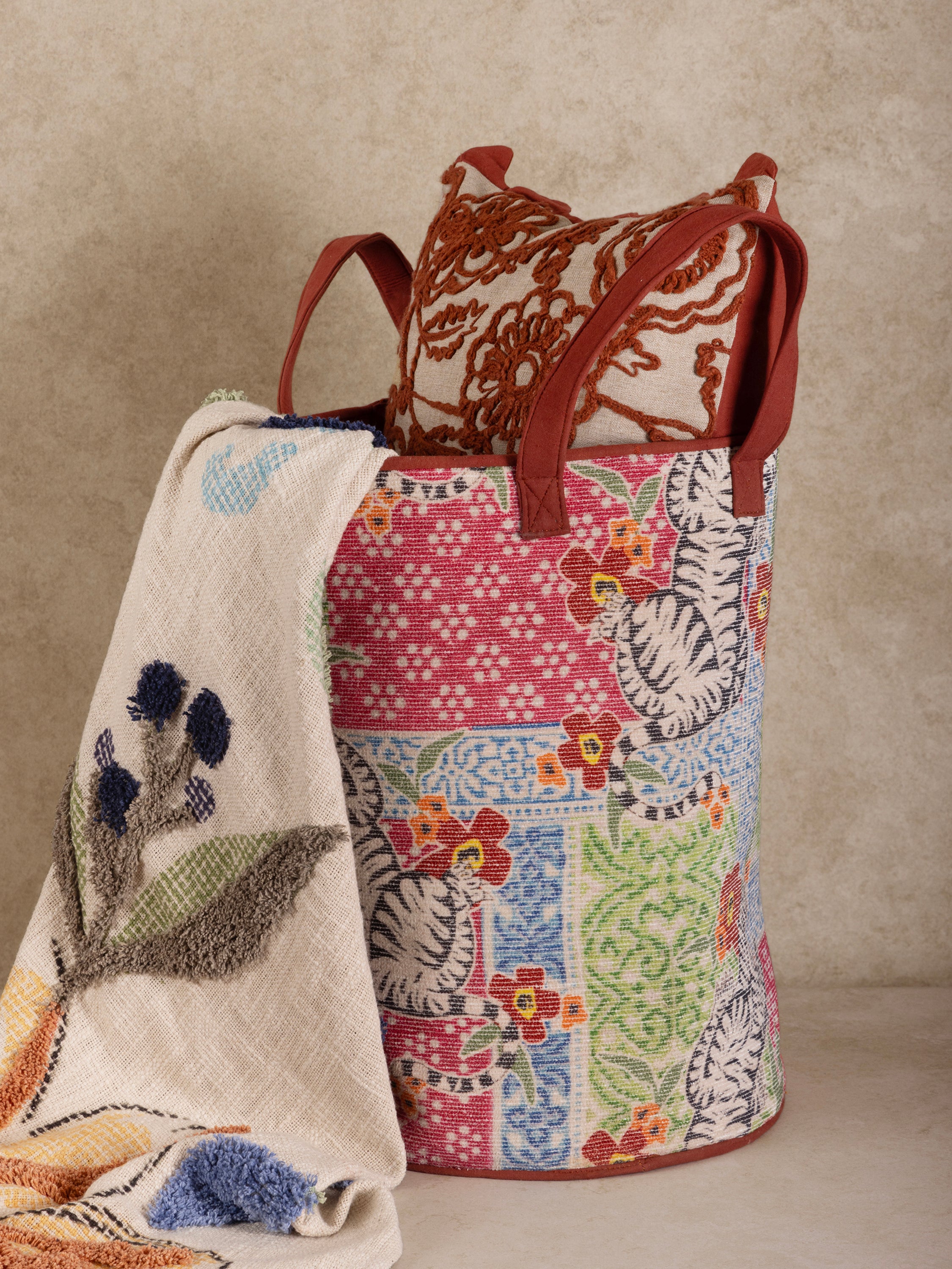 Printed canvas laundry hamper with vibrant pattern and structured form — luxury organizer