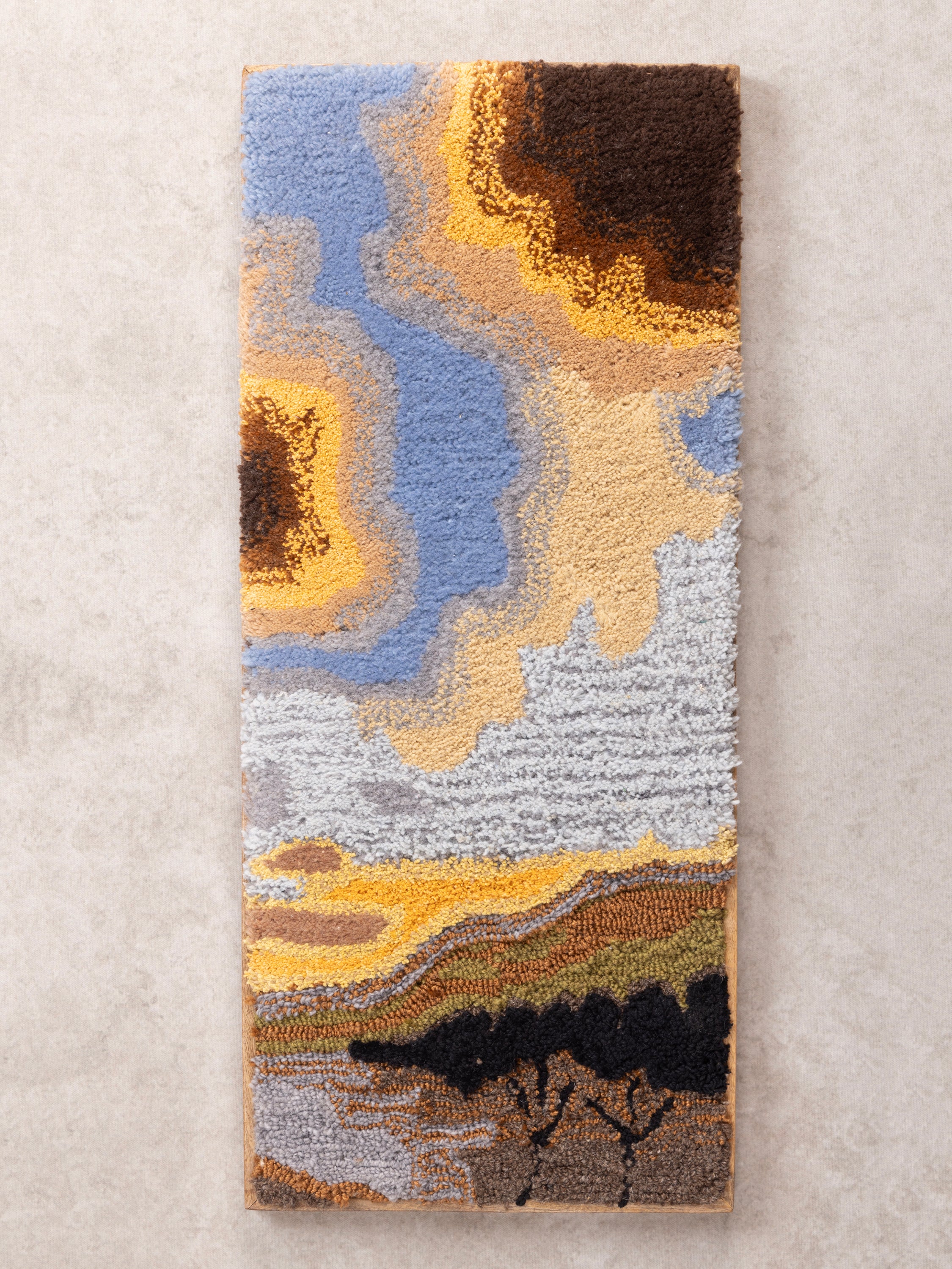 Hand-crafted wall art in cotton and wool with raised tufted landscape motif — artisan-made accent