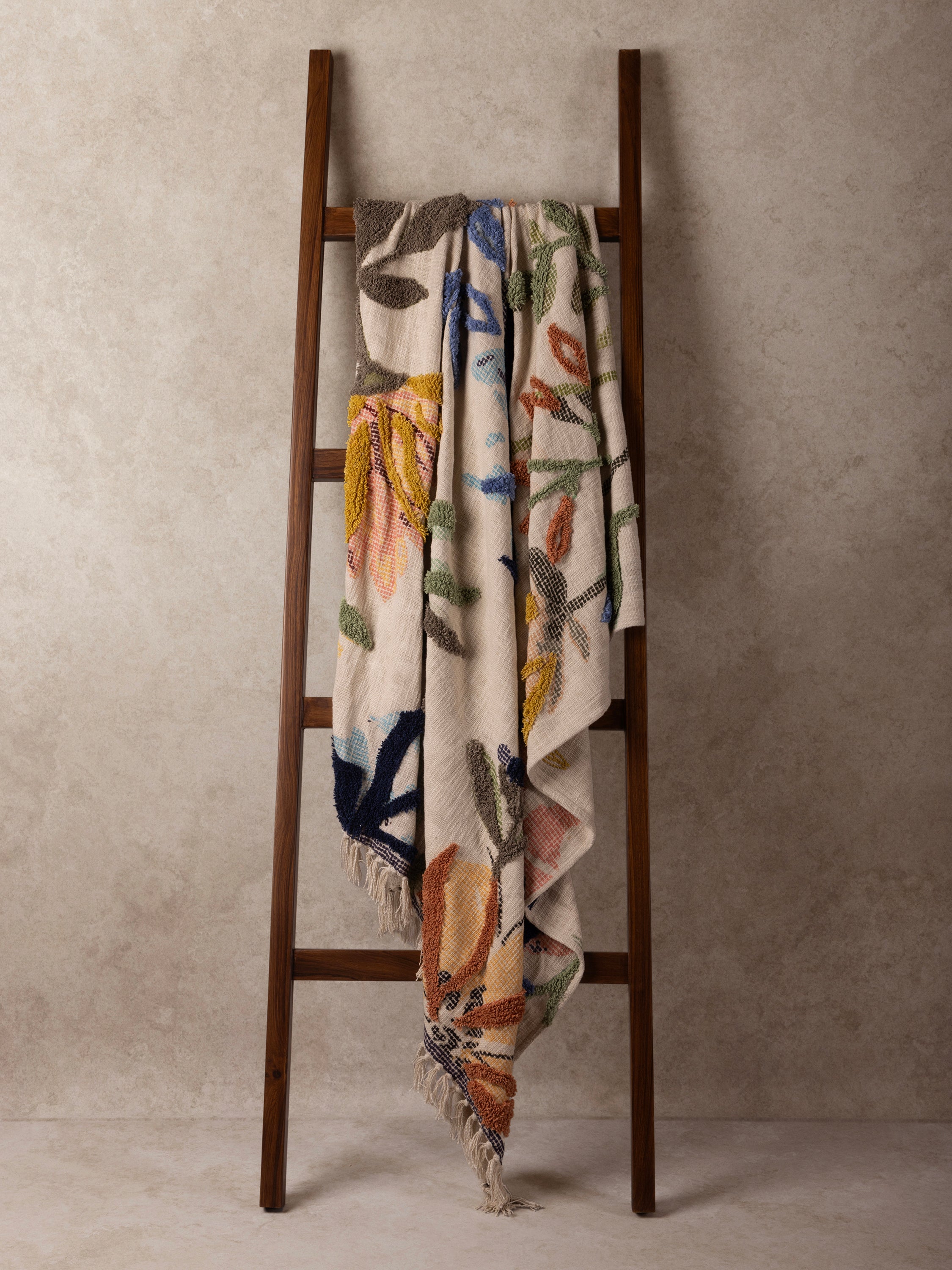 Finely woven cotton throw featuring raised tufted design and multicolored botanical print — refined home accent