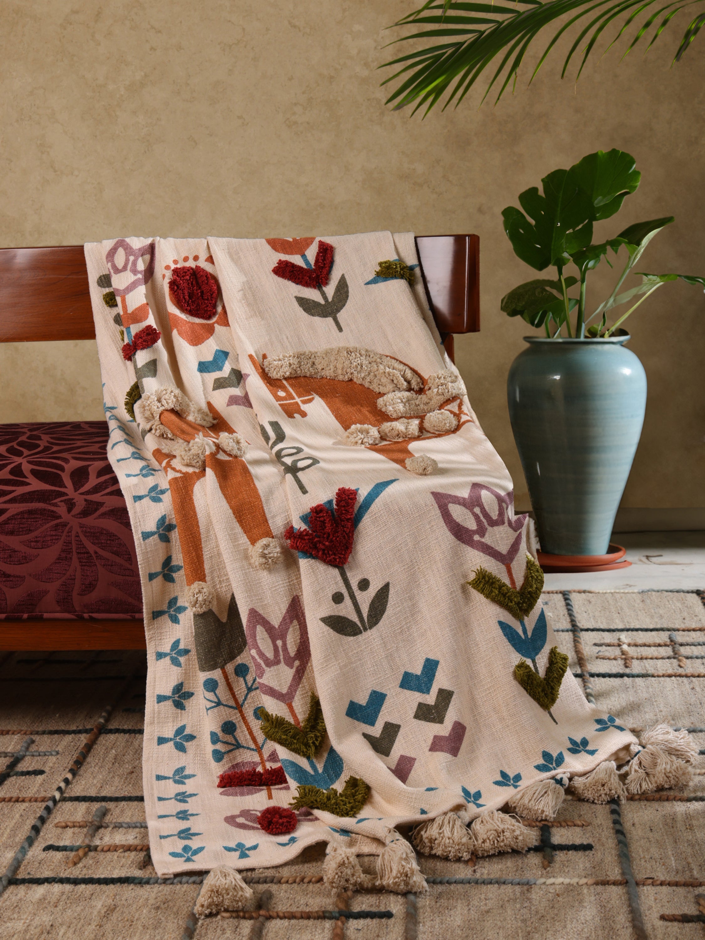 Soft woven throw with textured embroidery and fringe edges — serene handcrafted décor layer