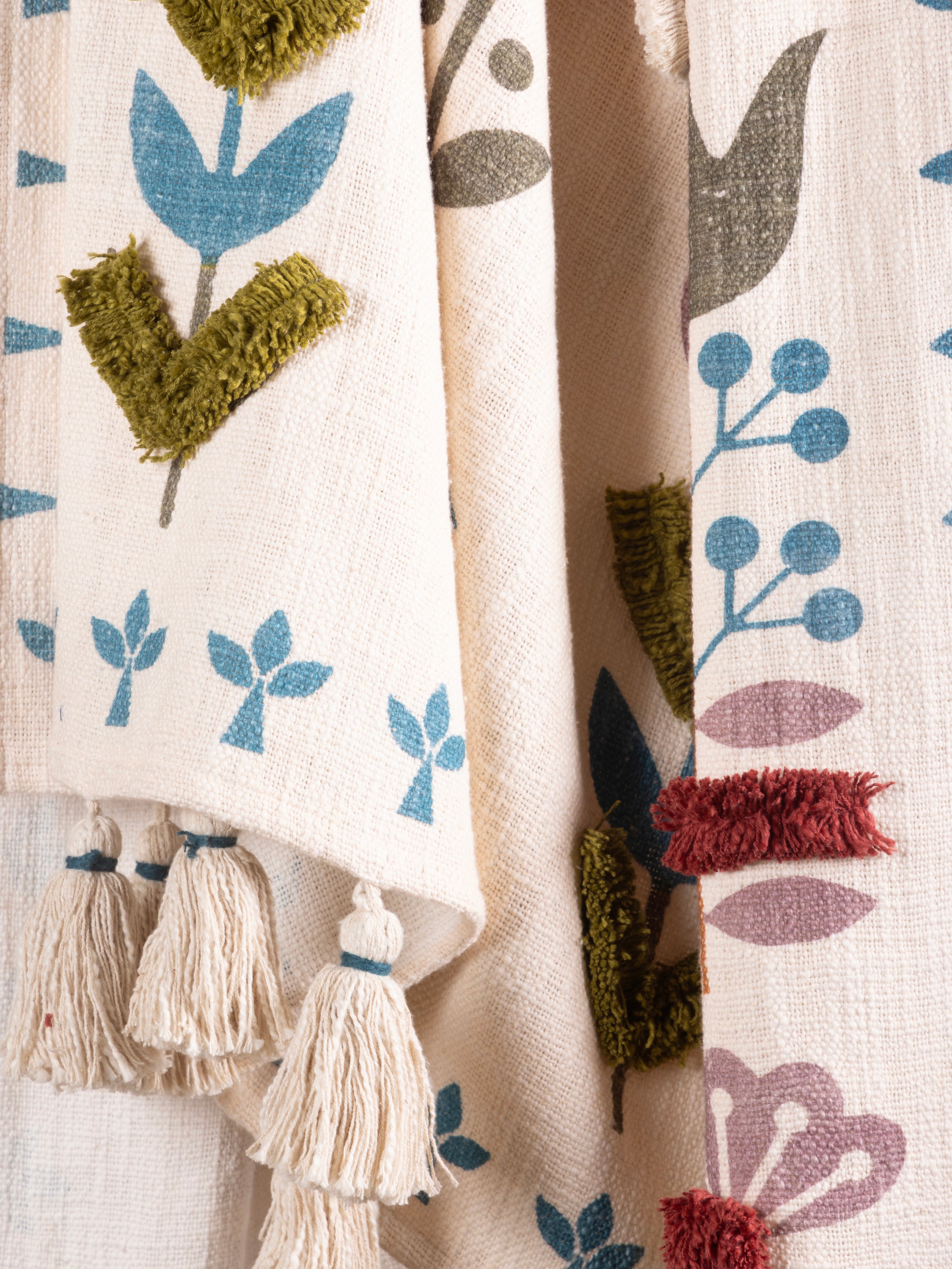 Natural cotton throw with sculpted tufted detailing and subtle colorwork — refined artisan design