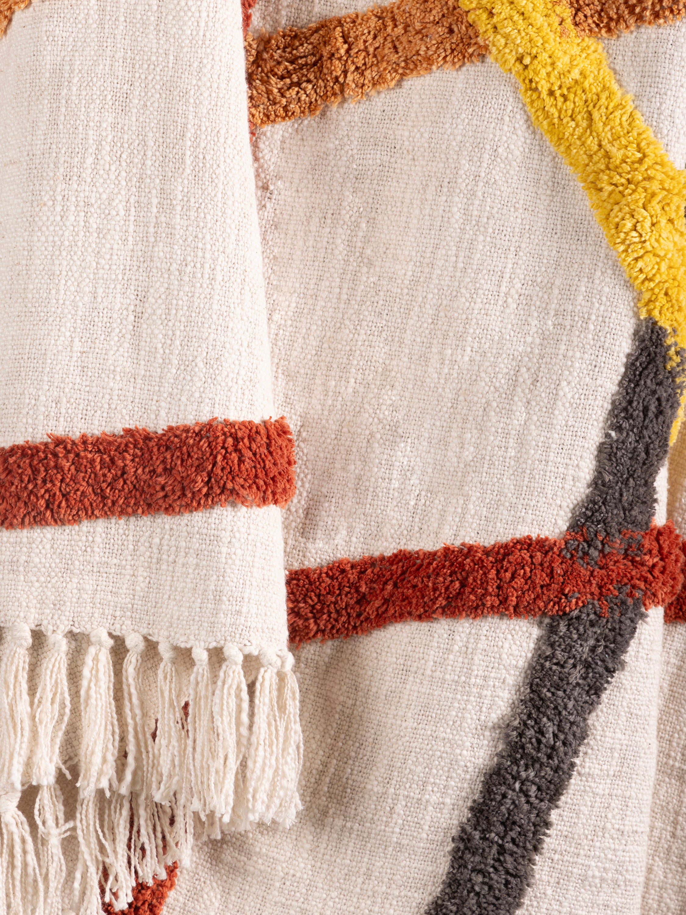 Artisan-made cotton throw with tactile surface and fringed edges — elegant decorative comfort