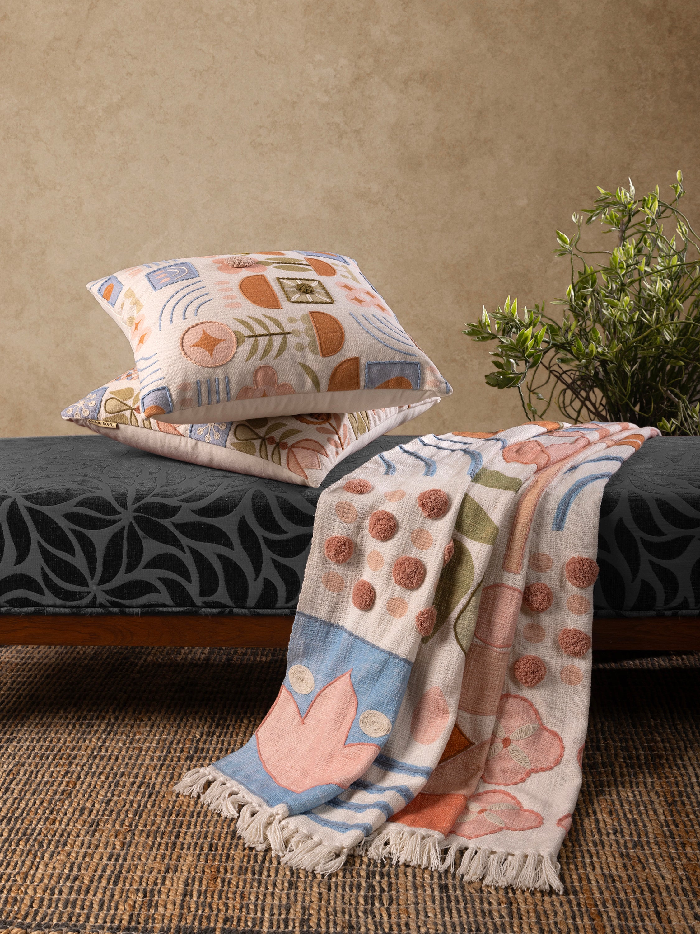 Joel throw in natural cotton with subtle floral-geometric motifs — refined living accessory