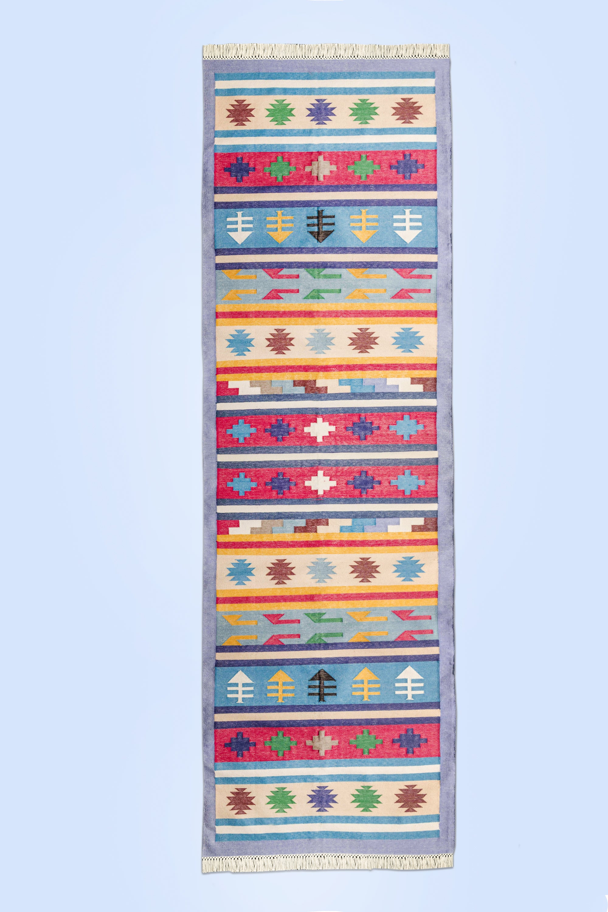 Colorful bohemian-style runner rug featuring intricate motifs and a flat-weave texture