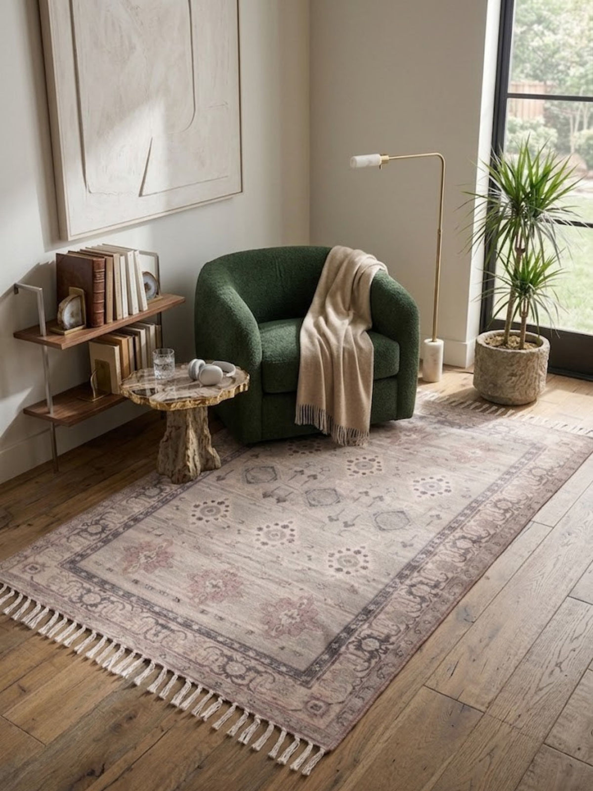 Flatwoven cotton and viscose rug in soft neutral tones, styled beneath a chair in a reading nook.