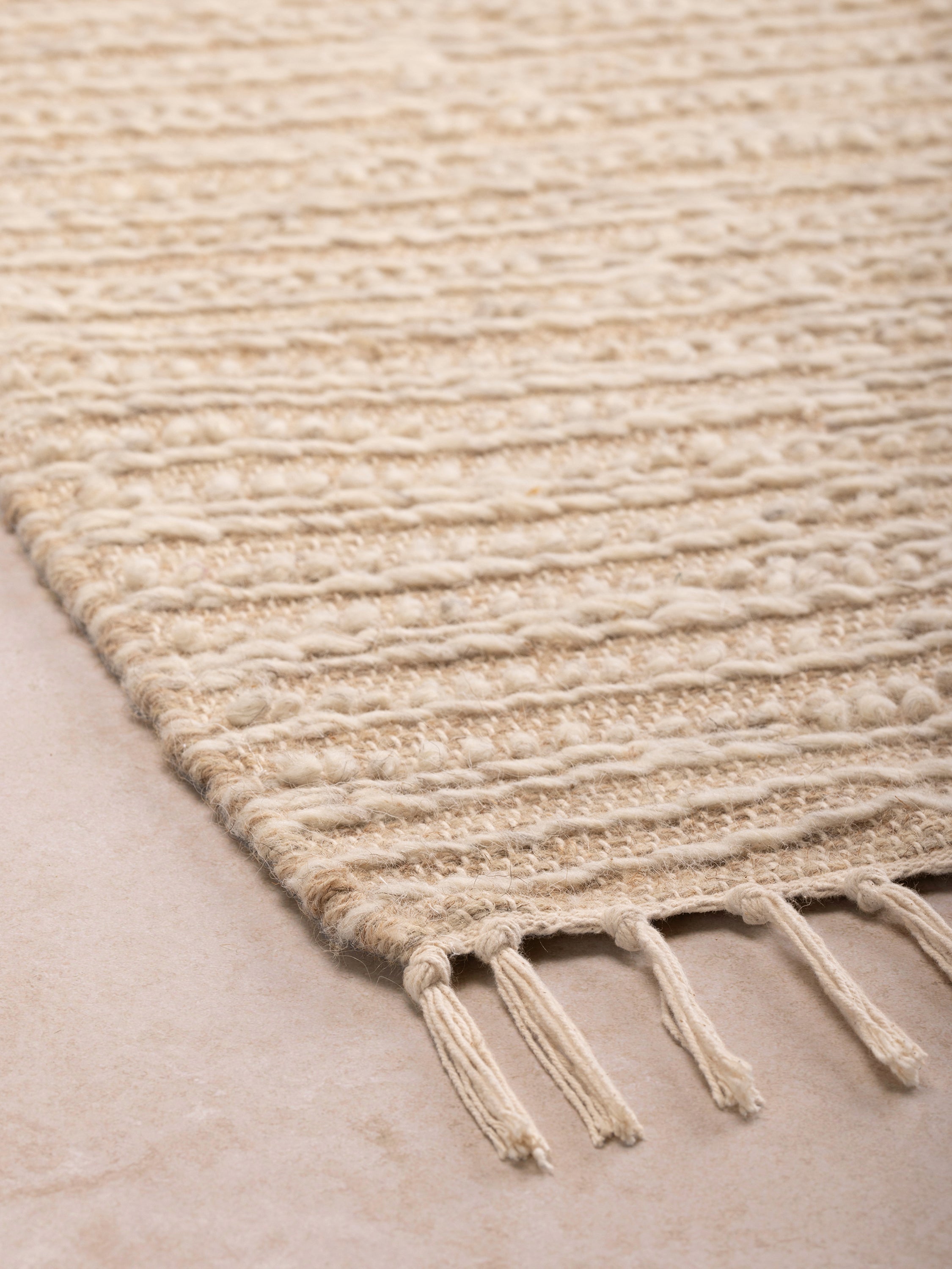 Low-pile area rug 5×8 in natural beige with artisan texture — modern material foundation