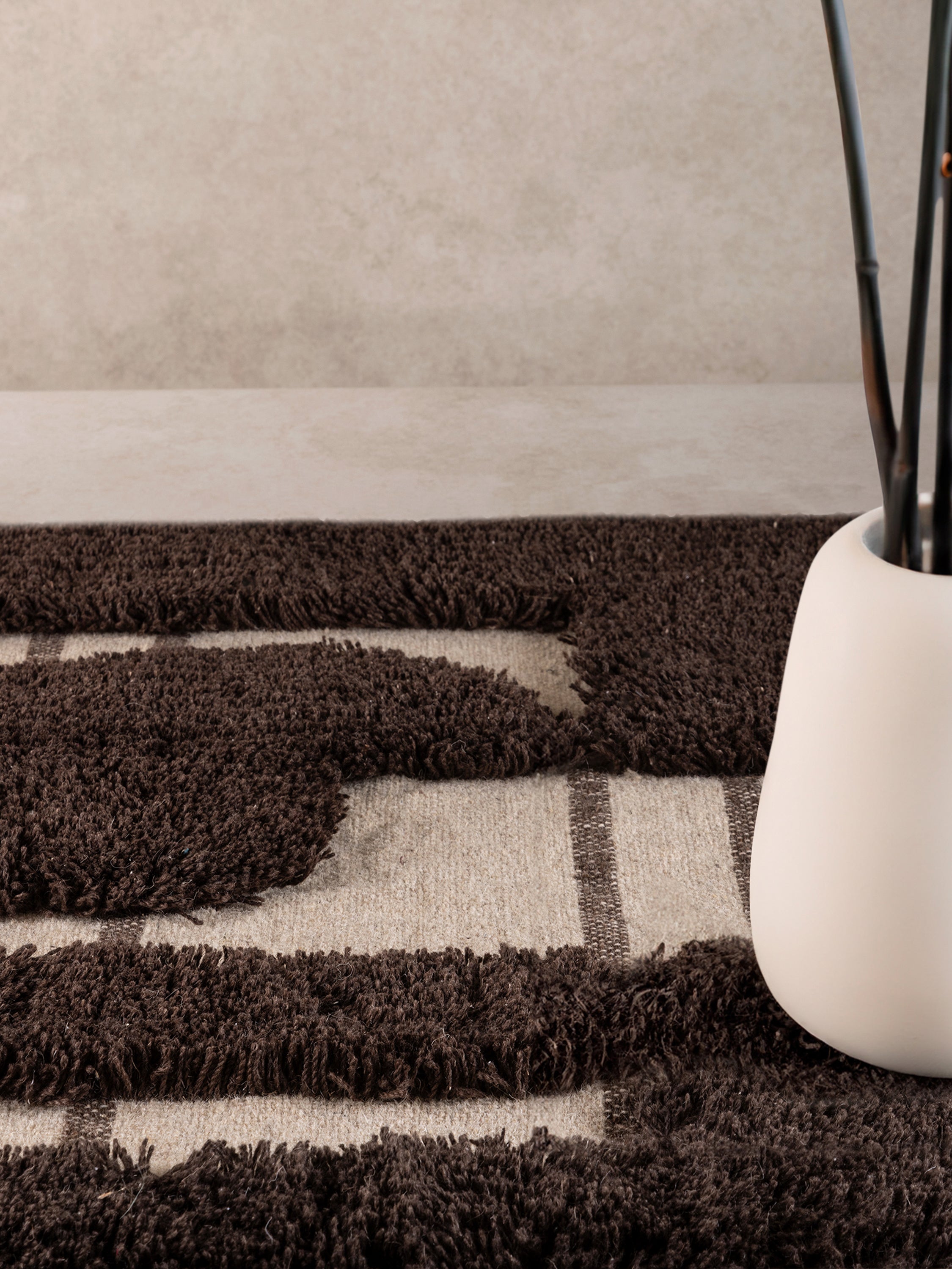 Nasik 5×8 area rug featuring high brown pile and low beige base — sculptural handcrafted décor