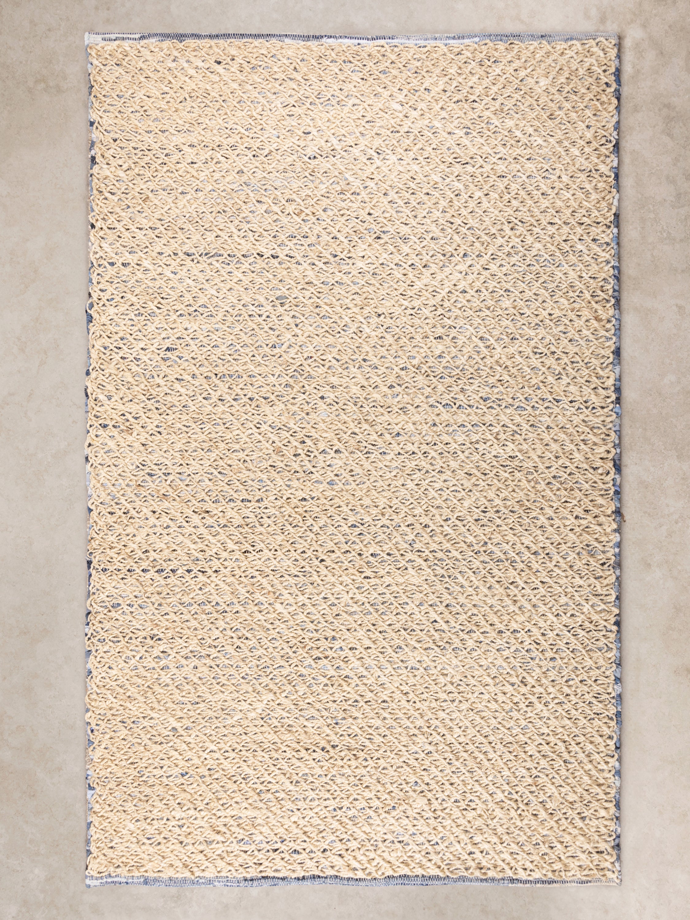Handwoven recycled denim and wool rug 5×8 in soft blue and beige — artisan sustainable décor