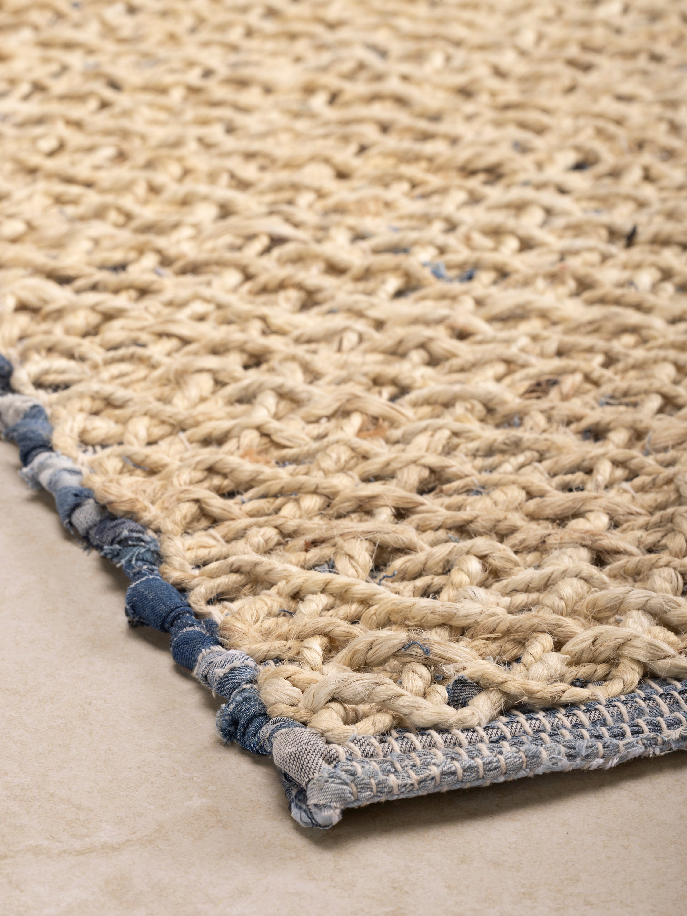 Soft blue beige handwoven area rug made from reclaimed denim — crafted floor texture