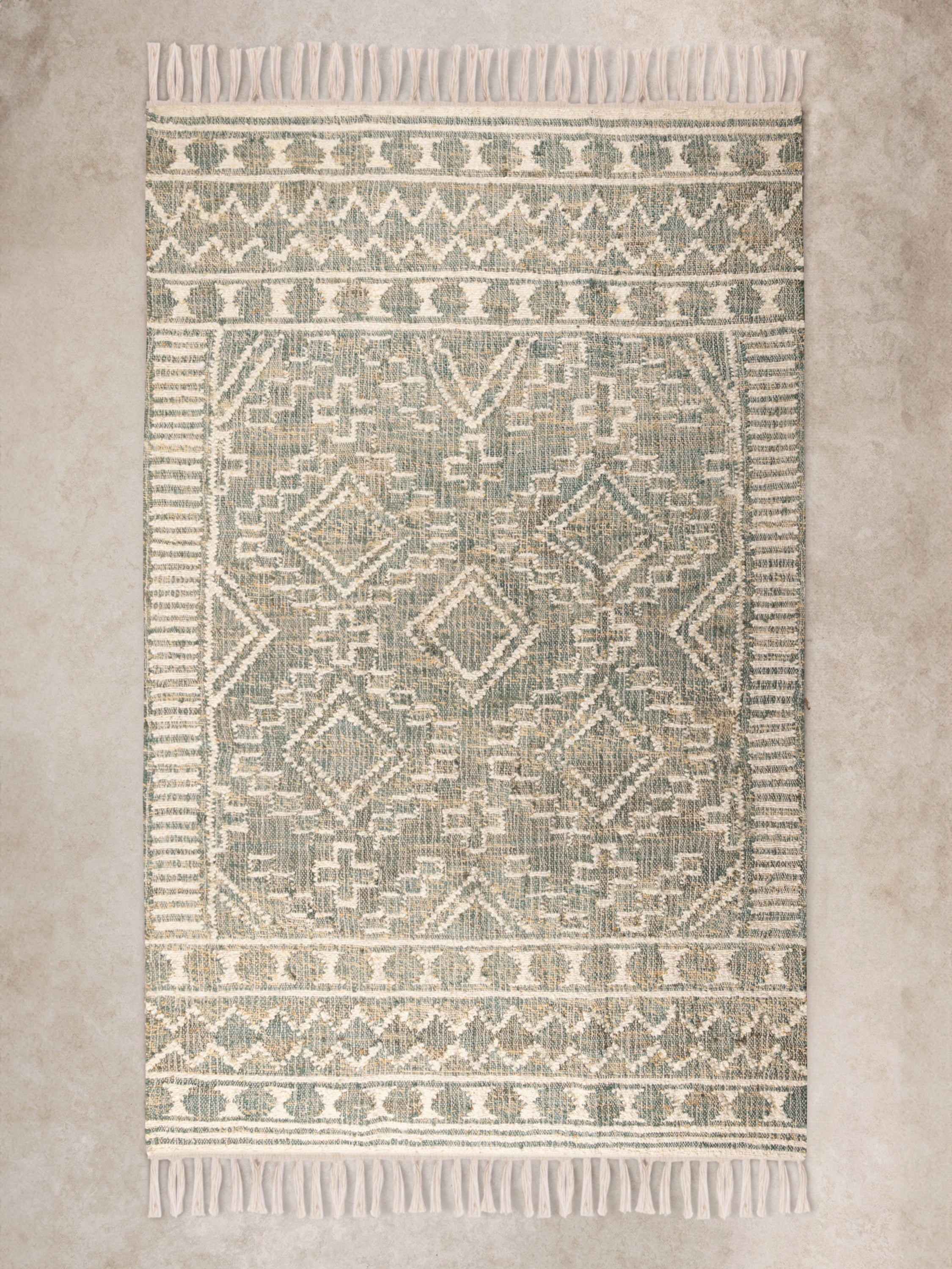 Hand-woven green and beige geometric area rug 5×8 with fringe — luxury artisan floor layering