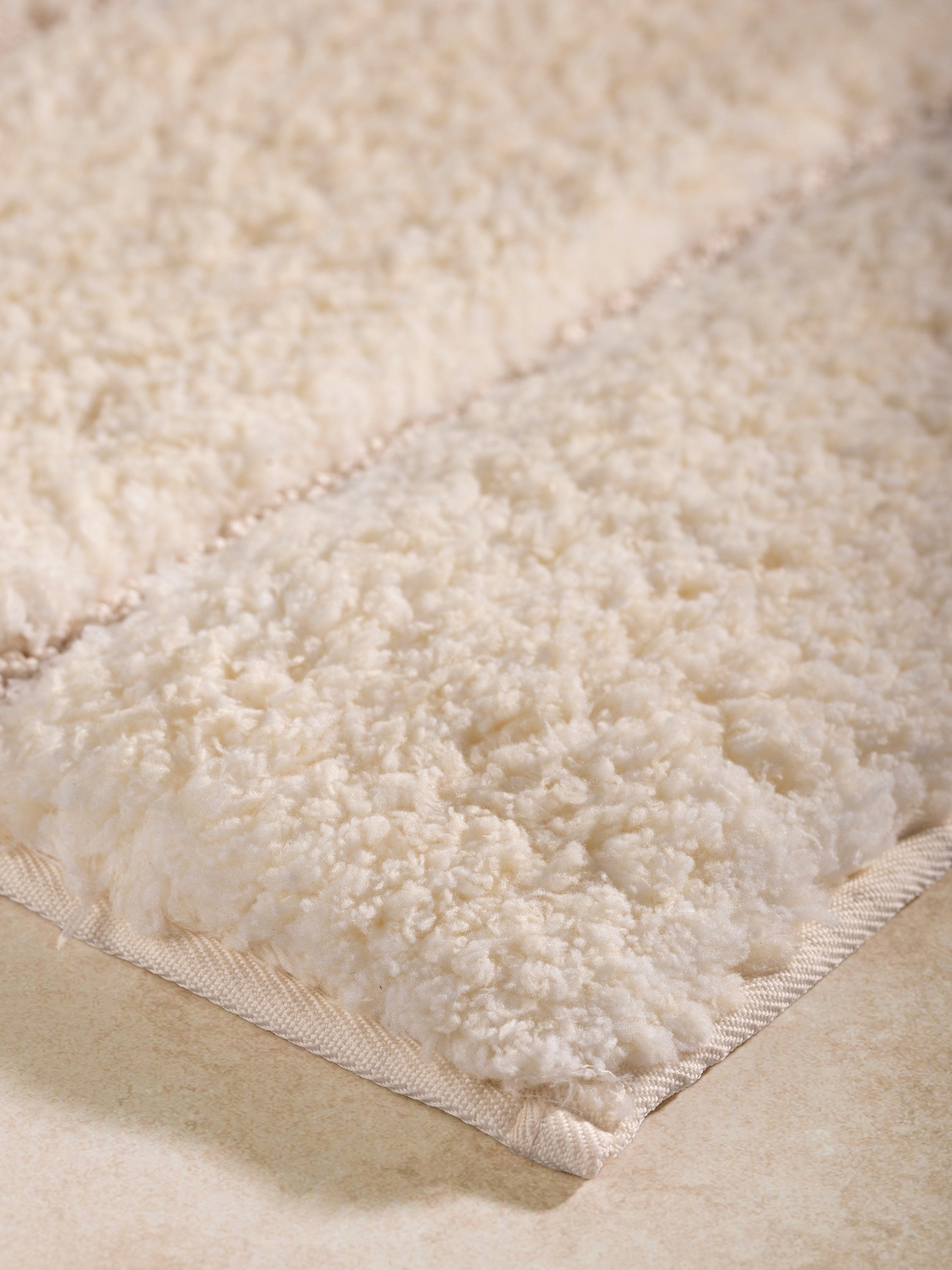 Ultra-soft ivory bathroom rug, perfect for keeping your feet warm and floors dry