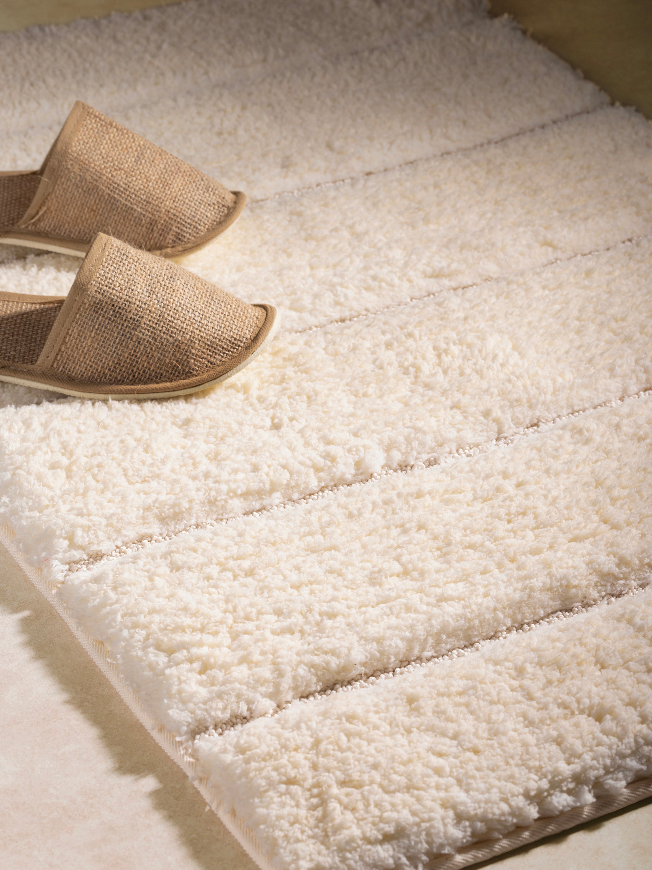Luxurious and absorbent ivory bath rug, designed for a spa-like experience at home
