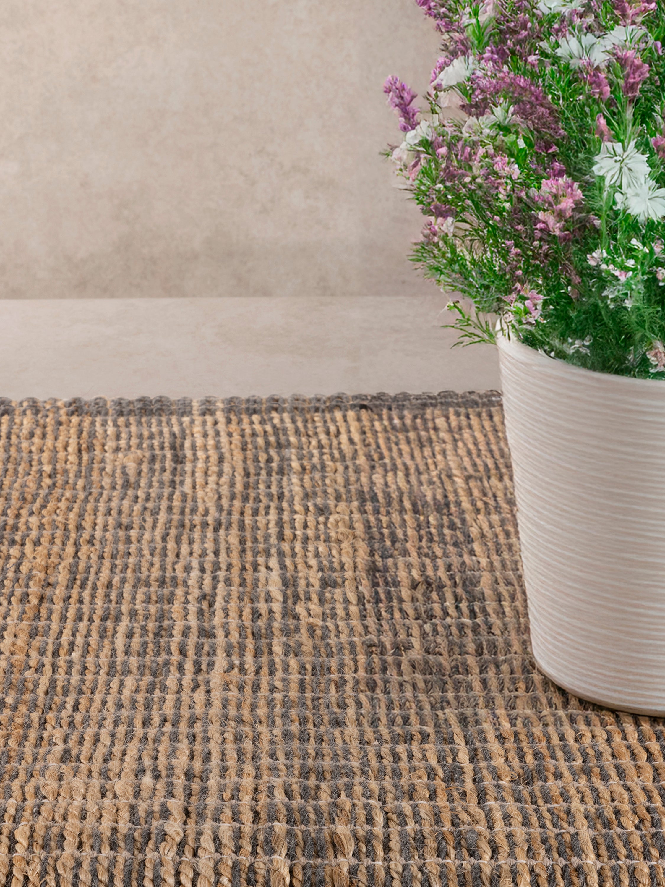 Eco-friendly beige and gray jute area rug with a minimalist woven texture for modern interiors