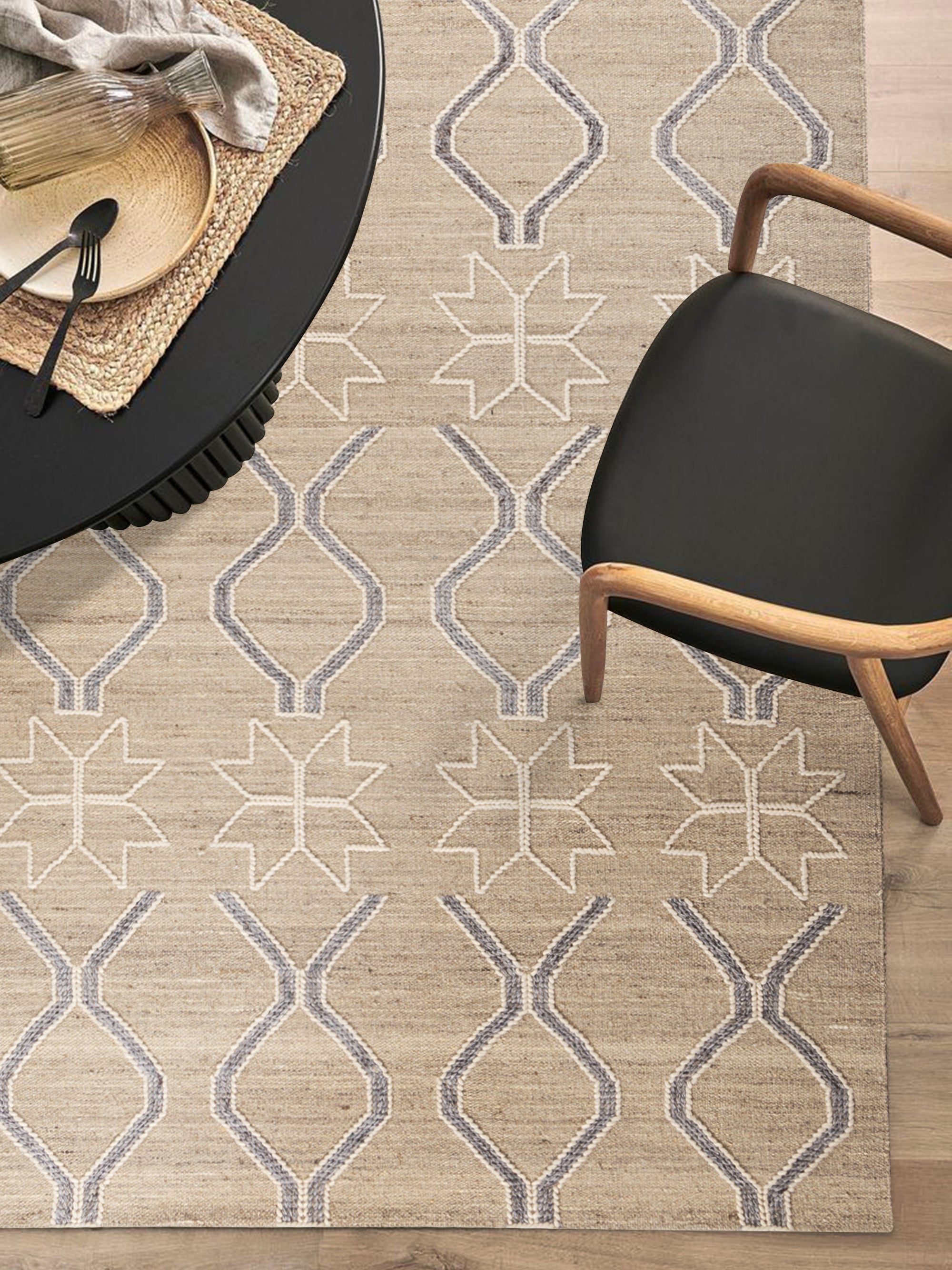 Close-up of rug surface featuring repeating linear motifs in soft blue tones against a beige ground