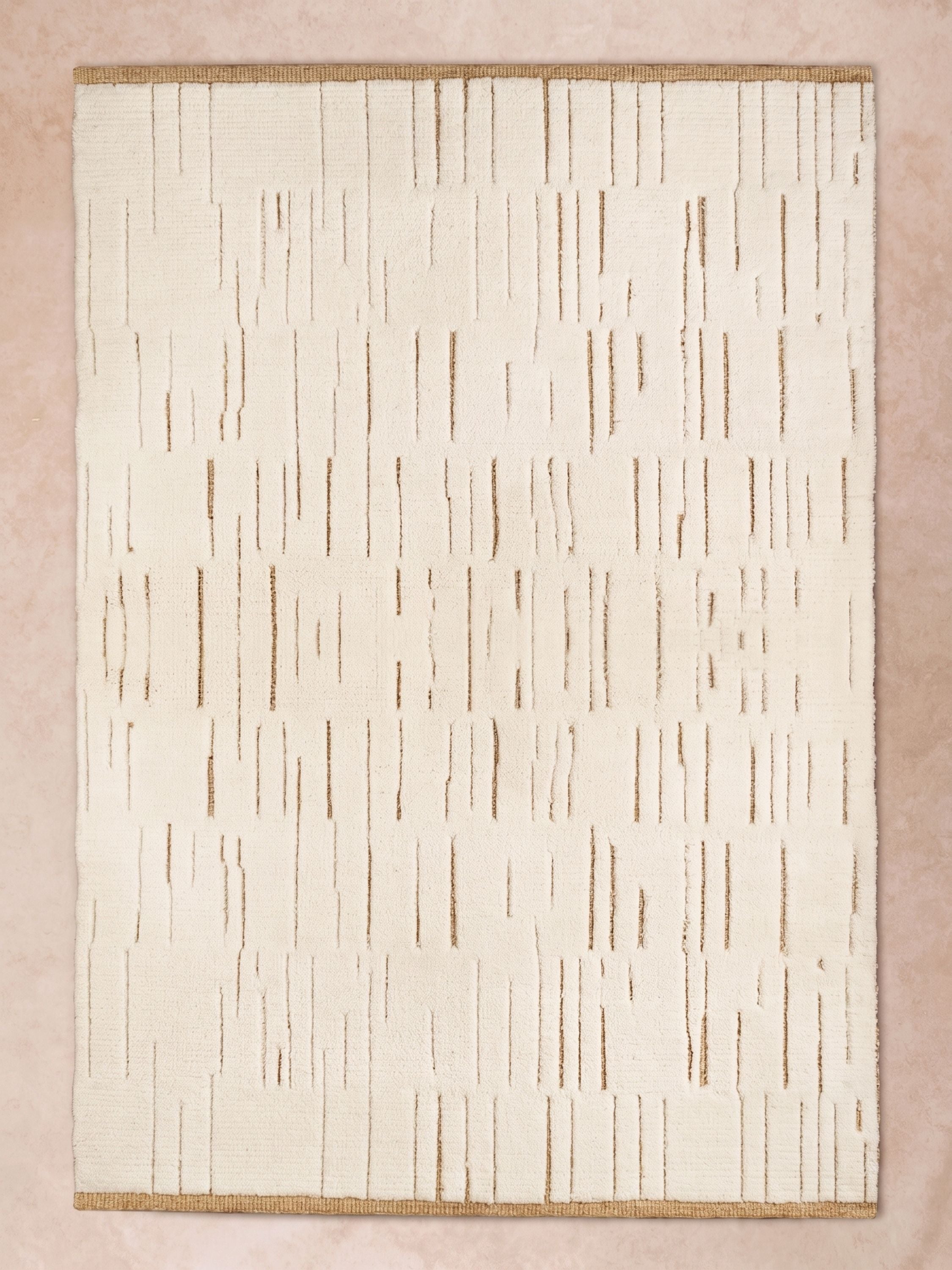 Ivory wool and natural jute area rug with subtle linear texture and tonal variation, shown in a soft neutral setting