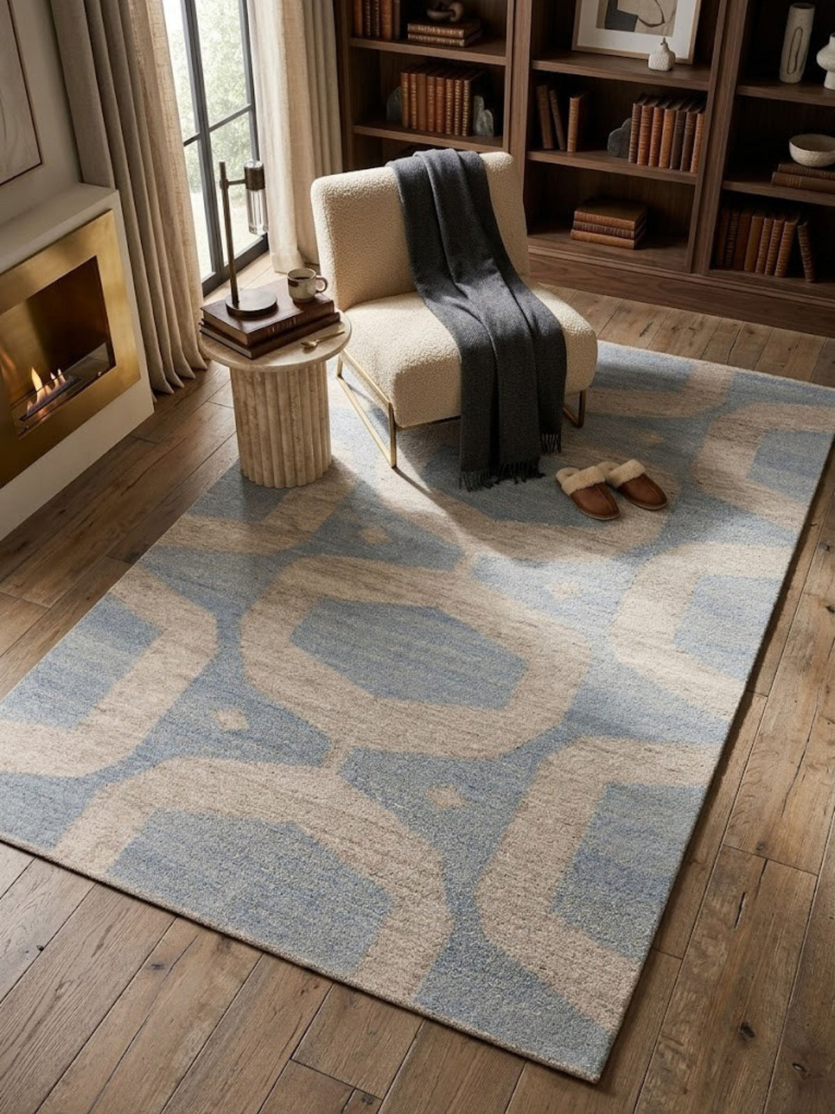Flatwoven wool rug with a crisp blue and sand color boundary, styled near a chair.