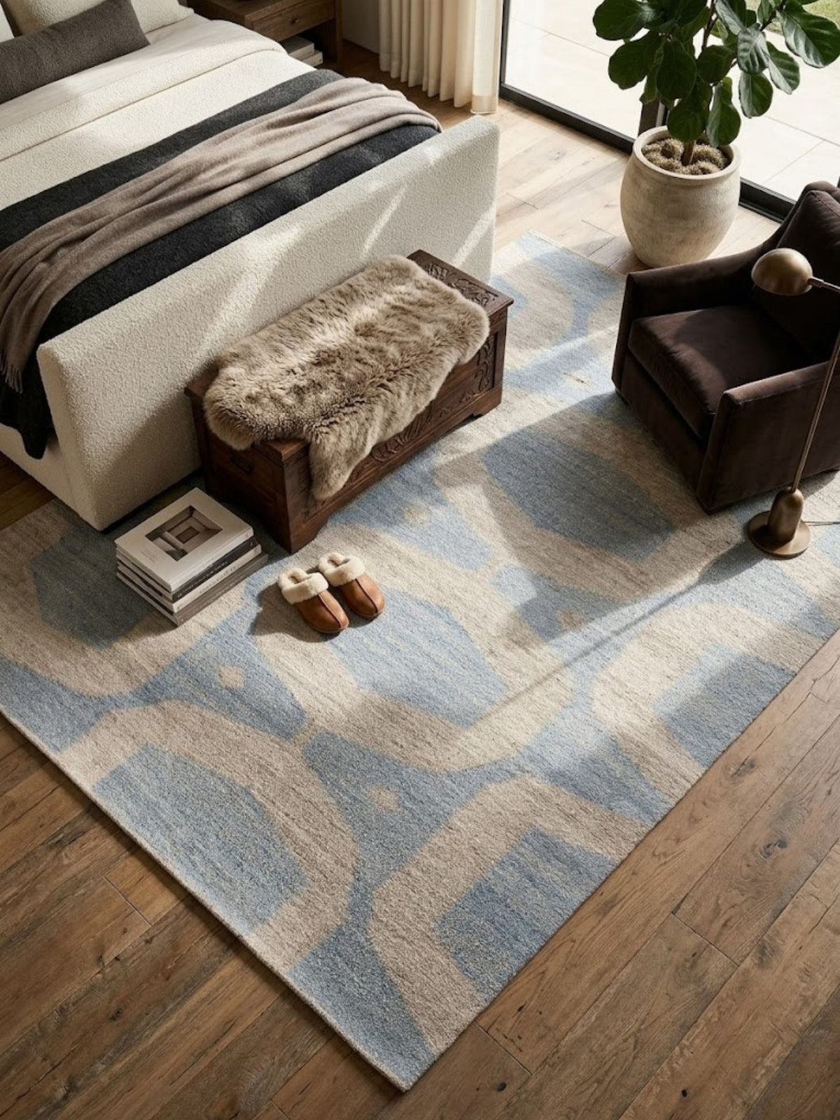 Flatwoven wool rug with blue and sand pattern, styled in a bedroom near a chest of drawers.