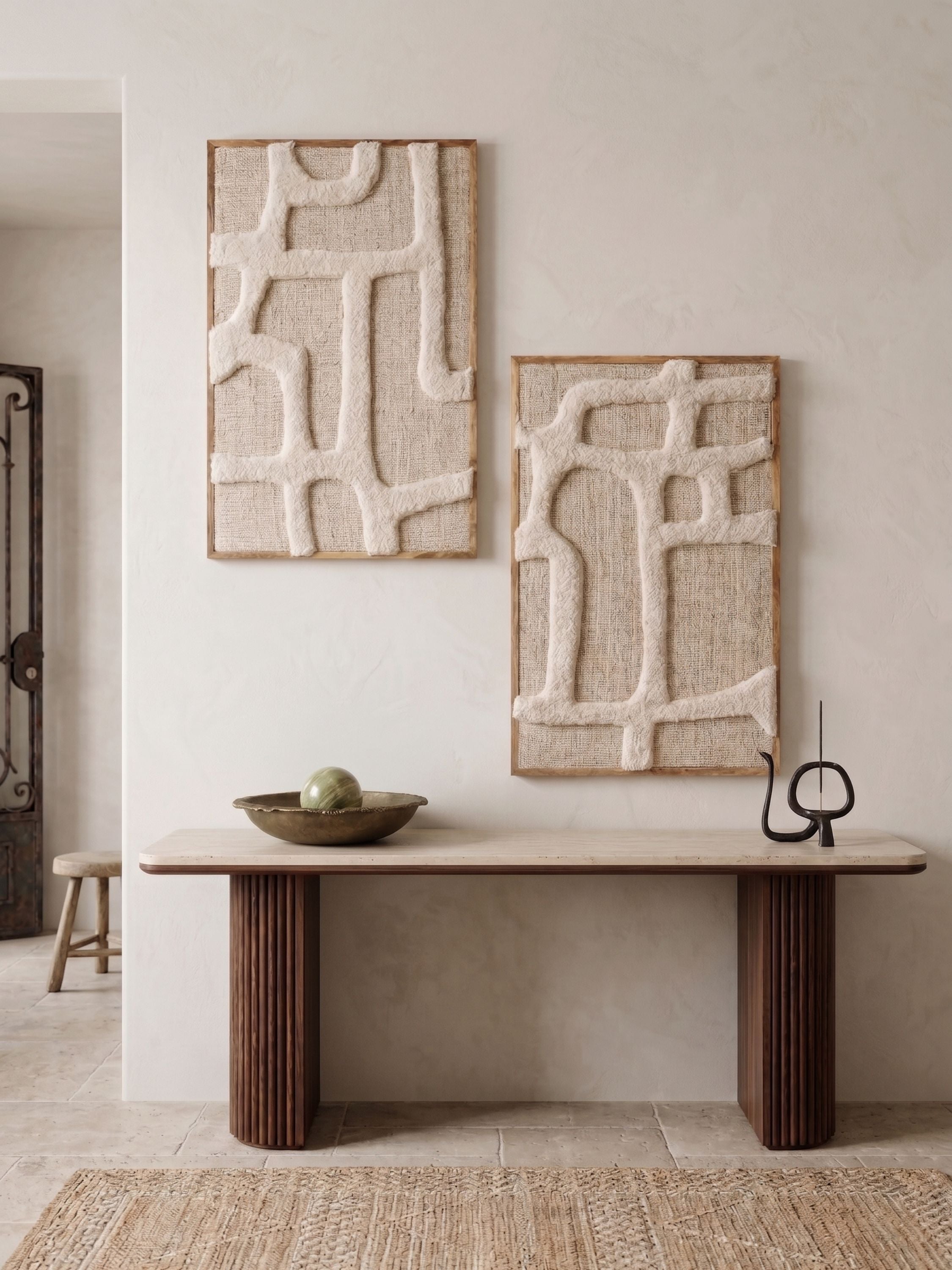 Tufted wool wall art with raised tonal texture in soft ivory, displayed above a wooden console in a neutral interior setting