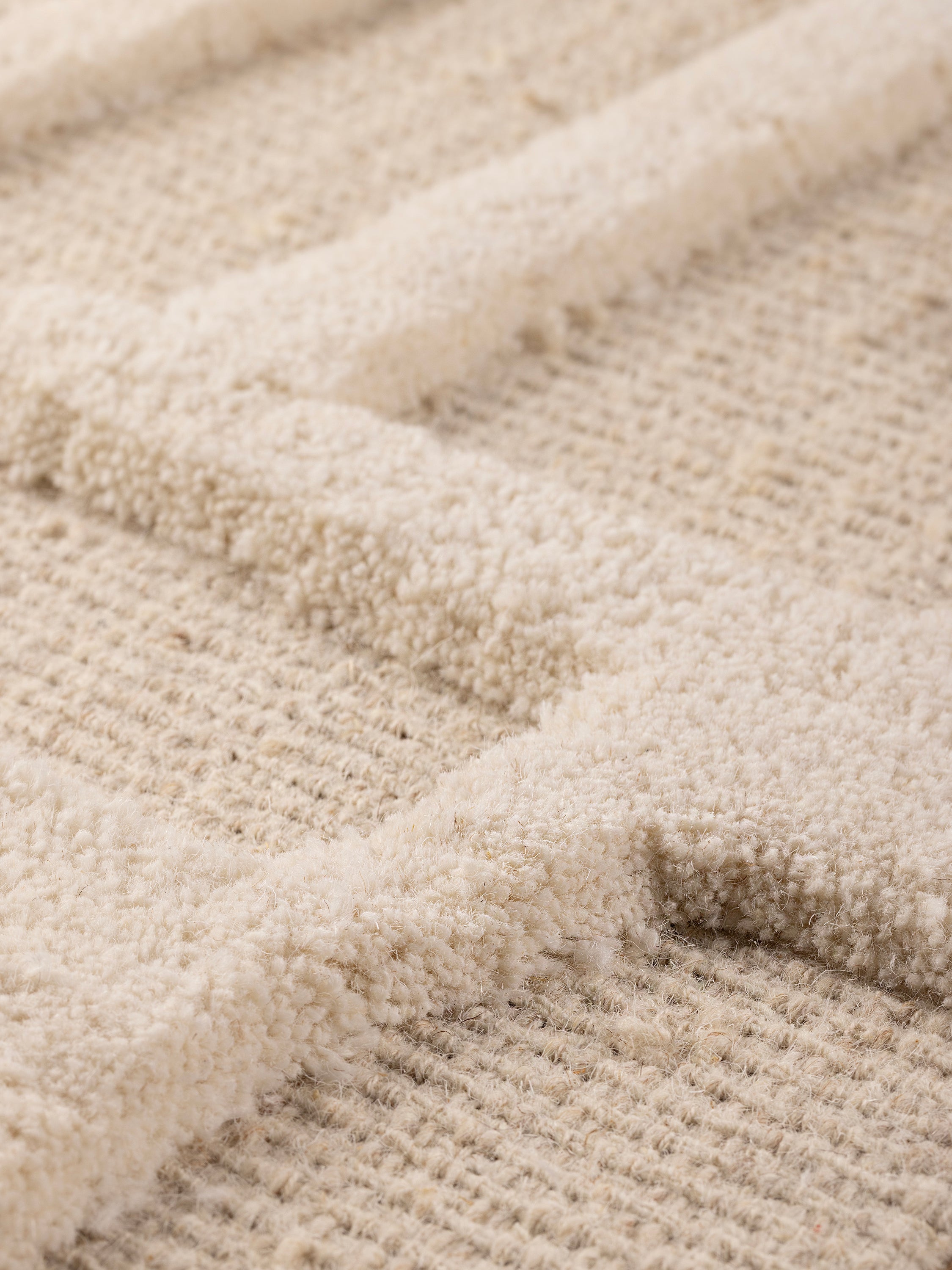 angled view highlighting dimensional tufting and woven wool texture