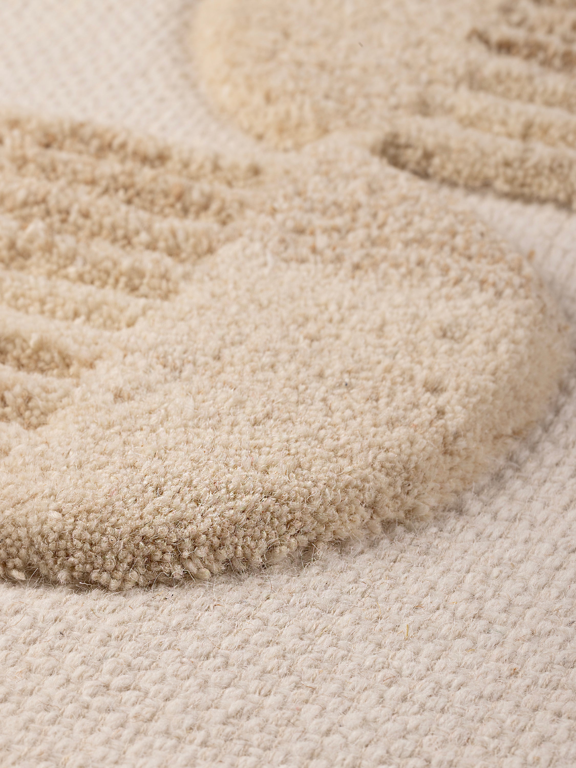 detailed corner view showing wood frame and textural wool surface