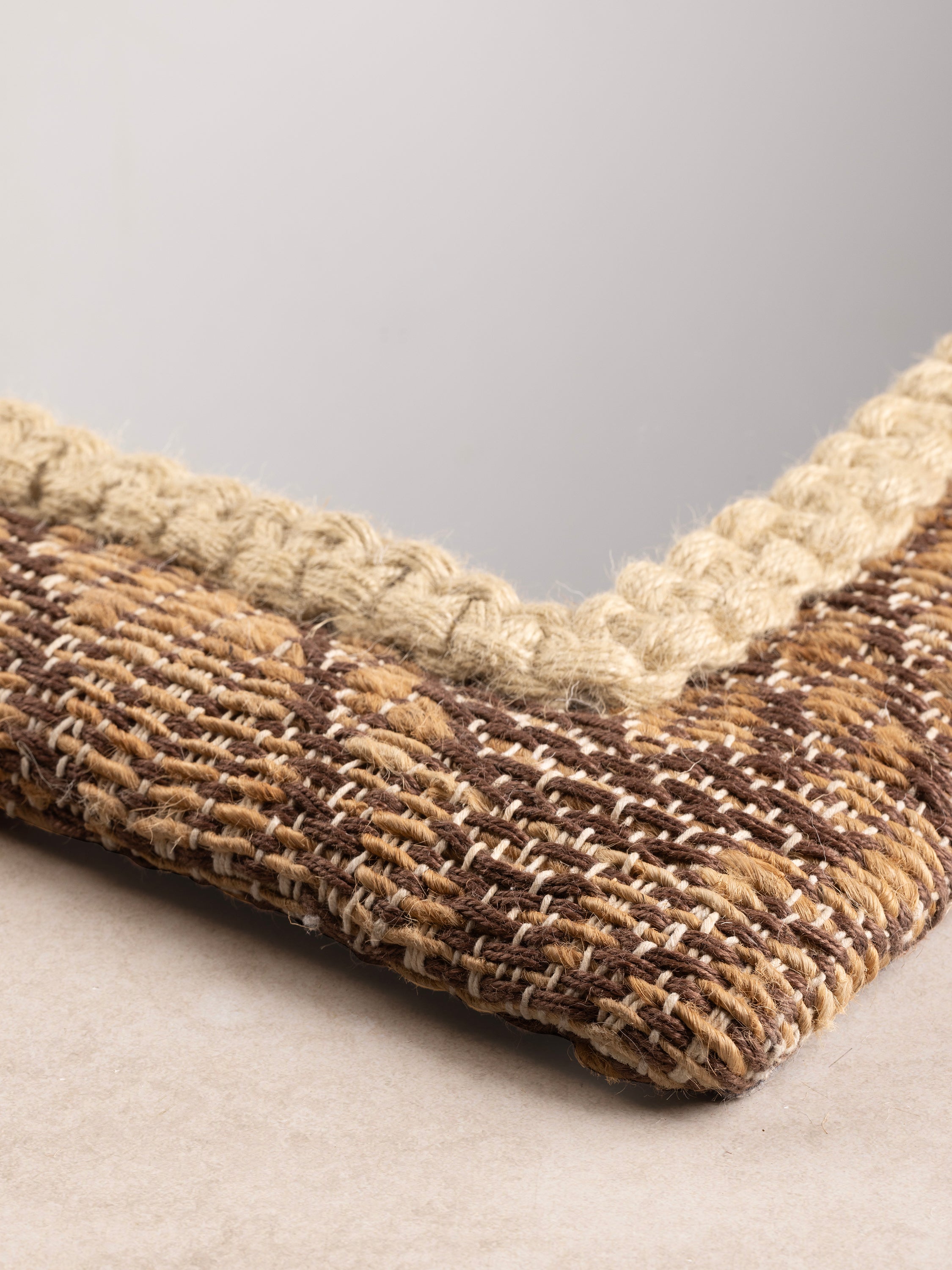 corner close-up showing frame craftsmanship and earthy woven fibers