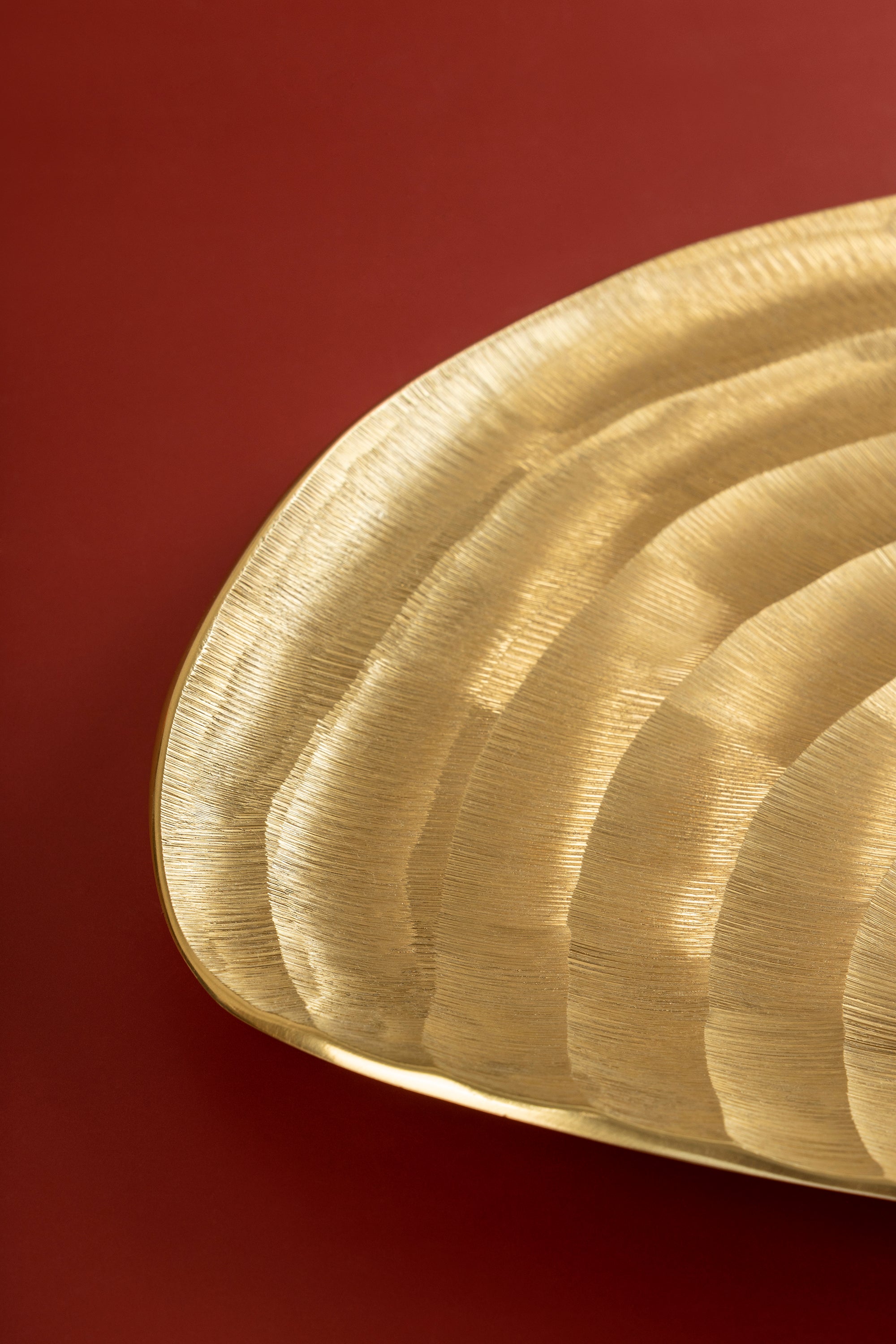 Artisan-made gold aluminum tray with ridged surface and polished edge — luxury surface layer