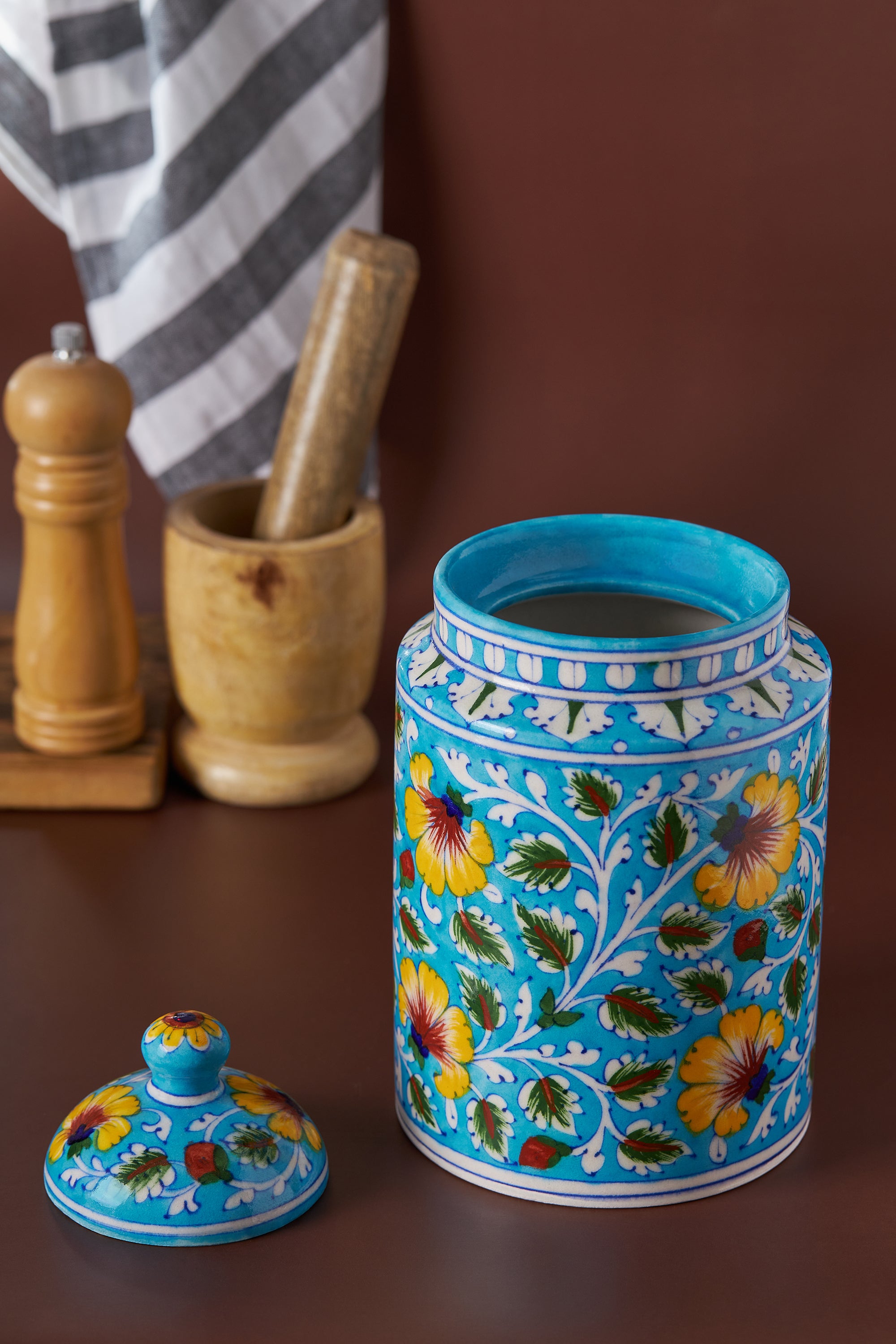 Vibrant blue ceramic canister with lid and intricate yellow floral design — refined kitchen accent