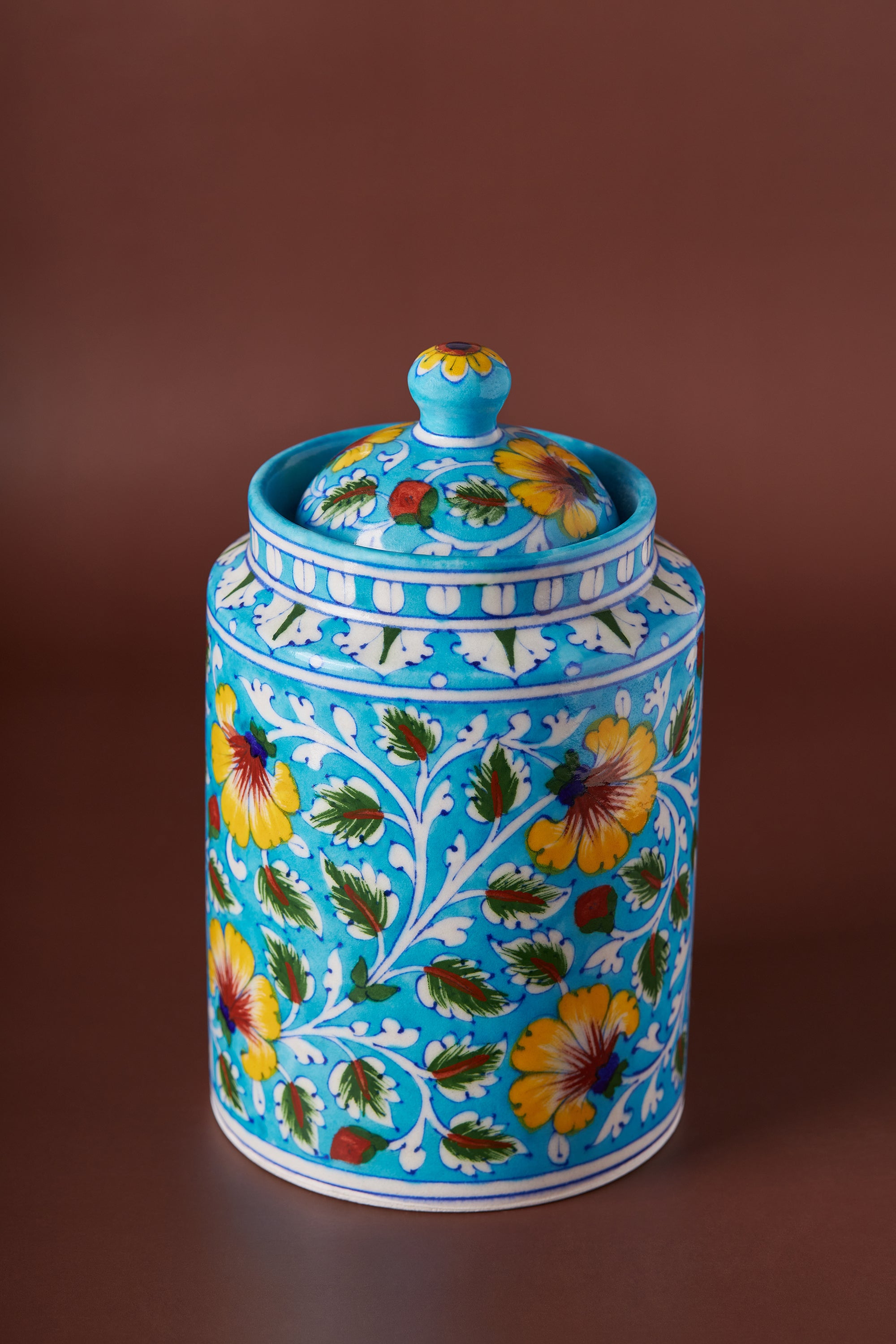 Handcrafted blue pottery kitchen canister with hand-painted floral motifs — artisan luxury storage piece