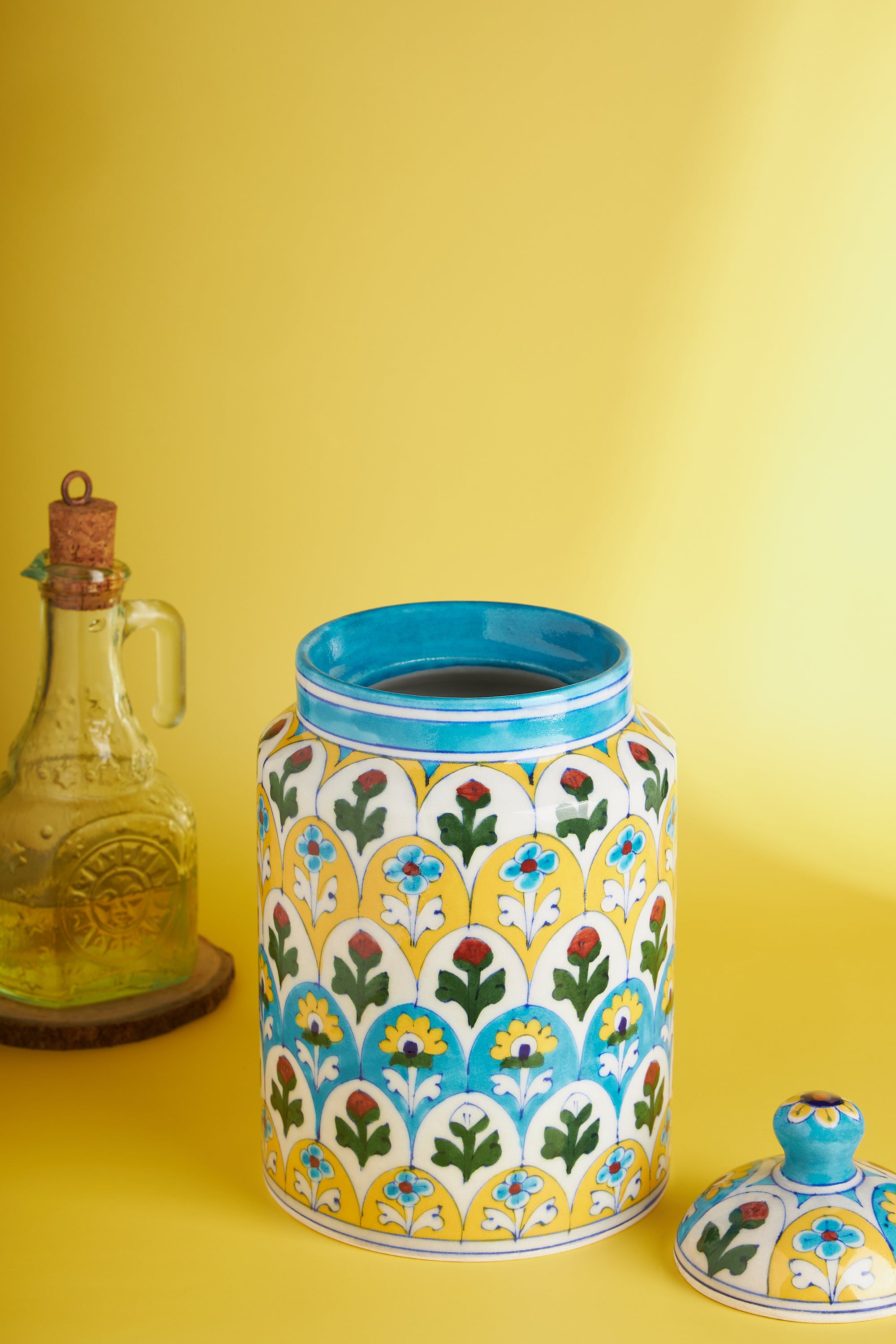 Vibrant blue and yellow ceramic canister with lid and floral design — refined kitchen accent
