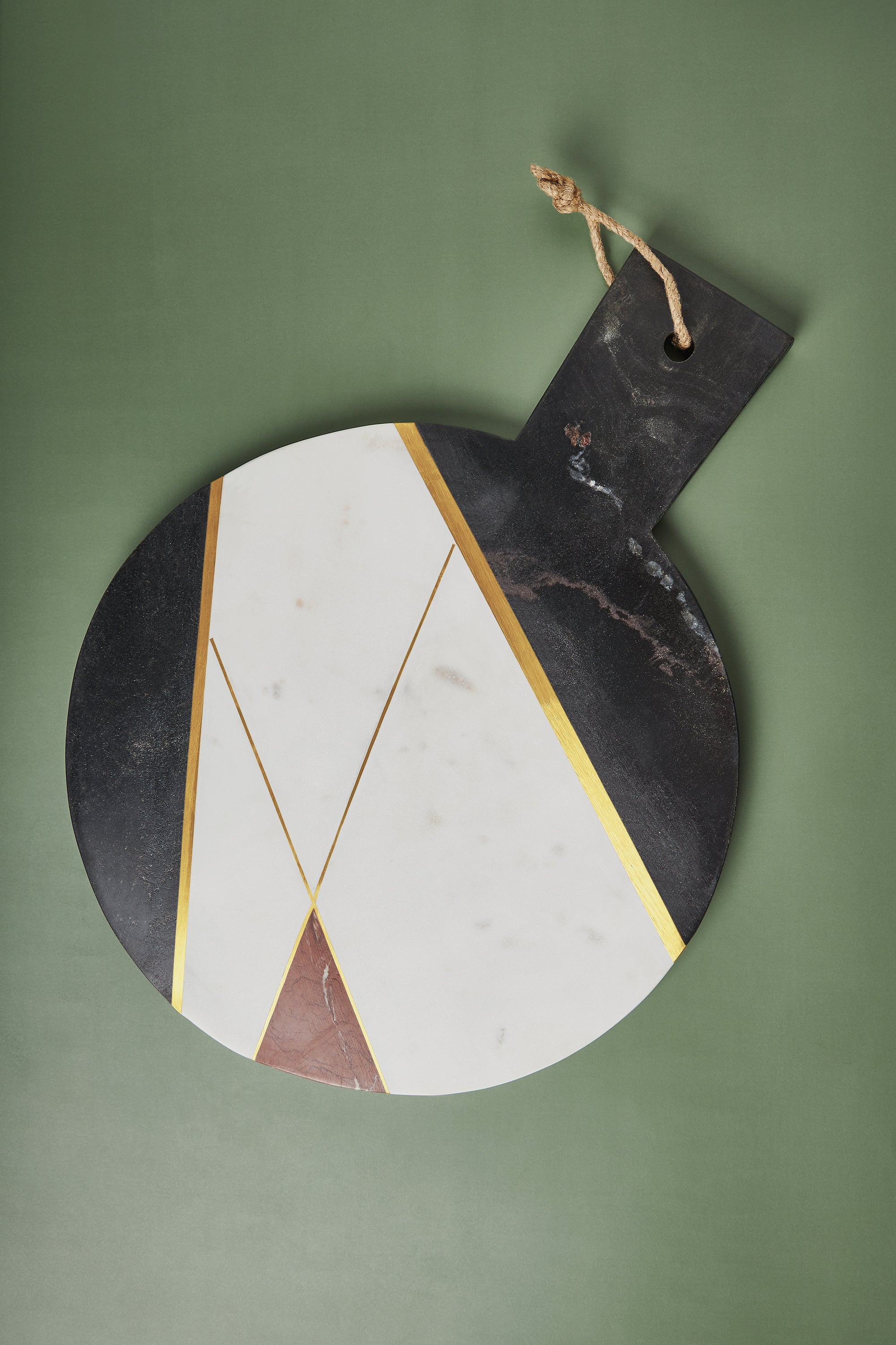 Handcrafted marble cheese board in white, black, and brown tones with brass detailing — artisan luxury serve piece