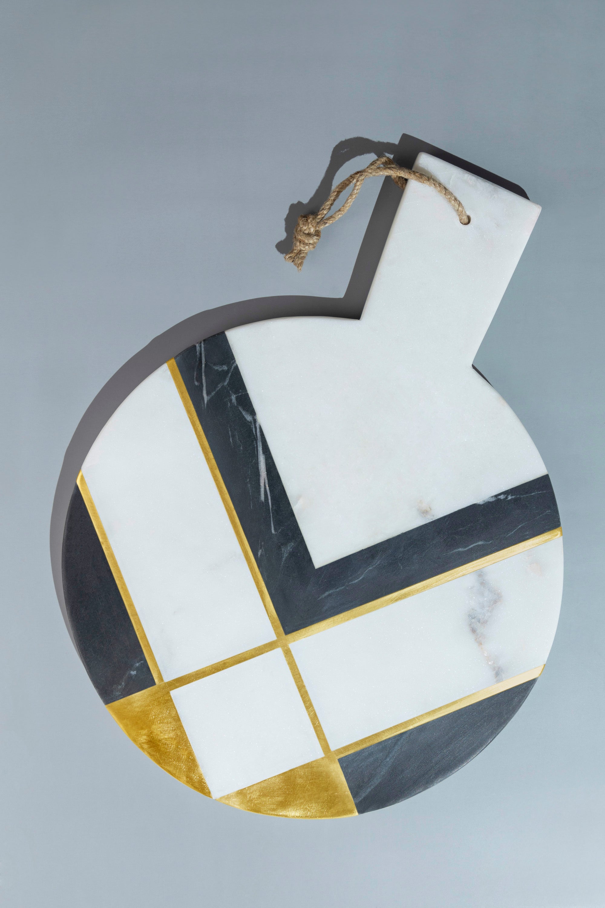 Handcrafted white marble cheese board with brass inlay detail — artisan luxury serve piece