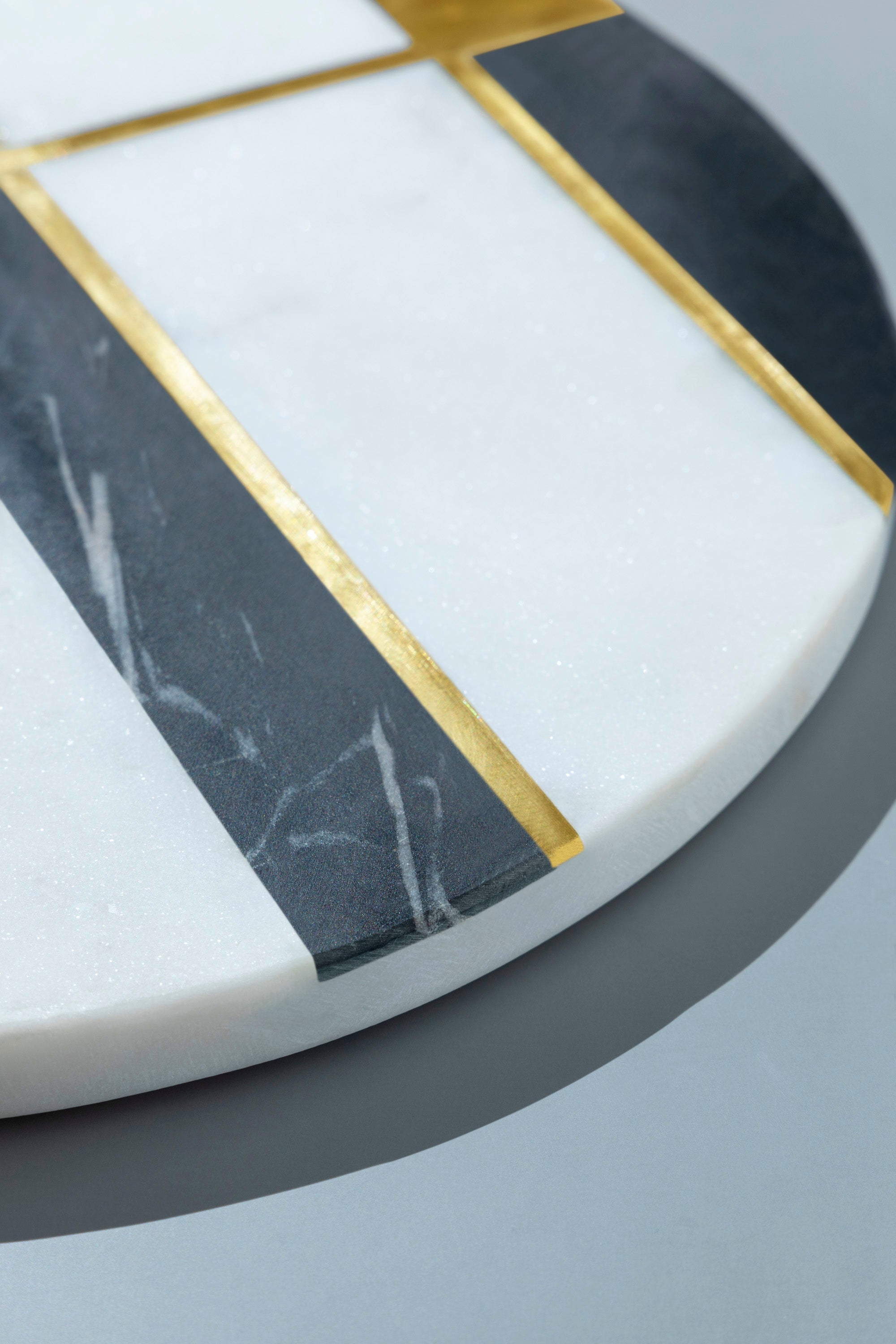 Artisan-made marble cheese board featuring refined brass lines and natural stone texture
