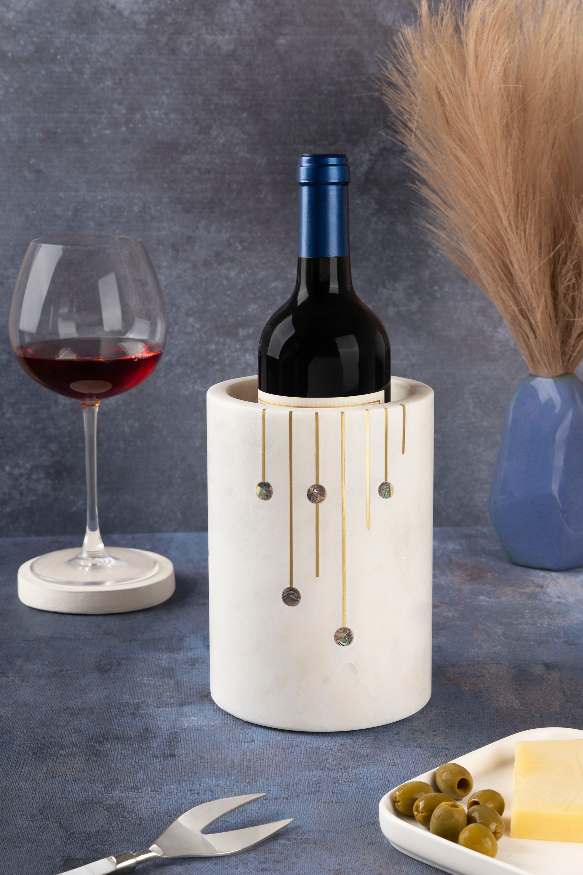 Polished white marble wine chiller with metallic and shell detailing — refined serving piece