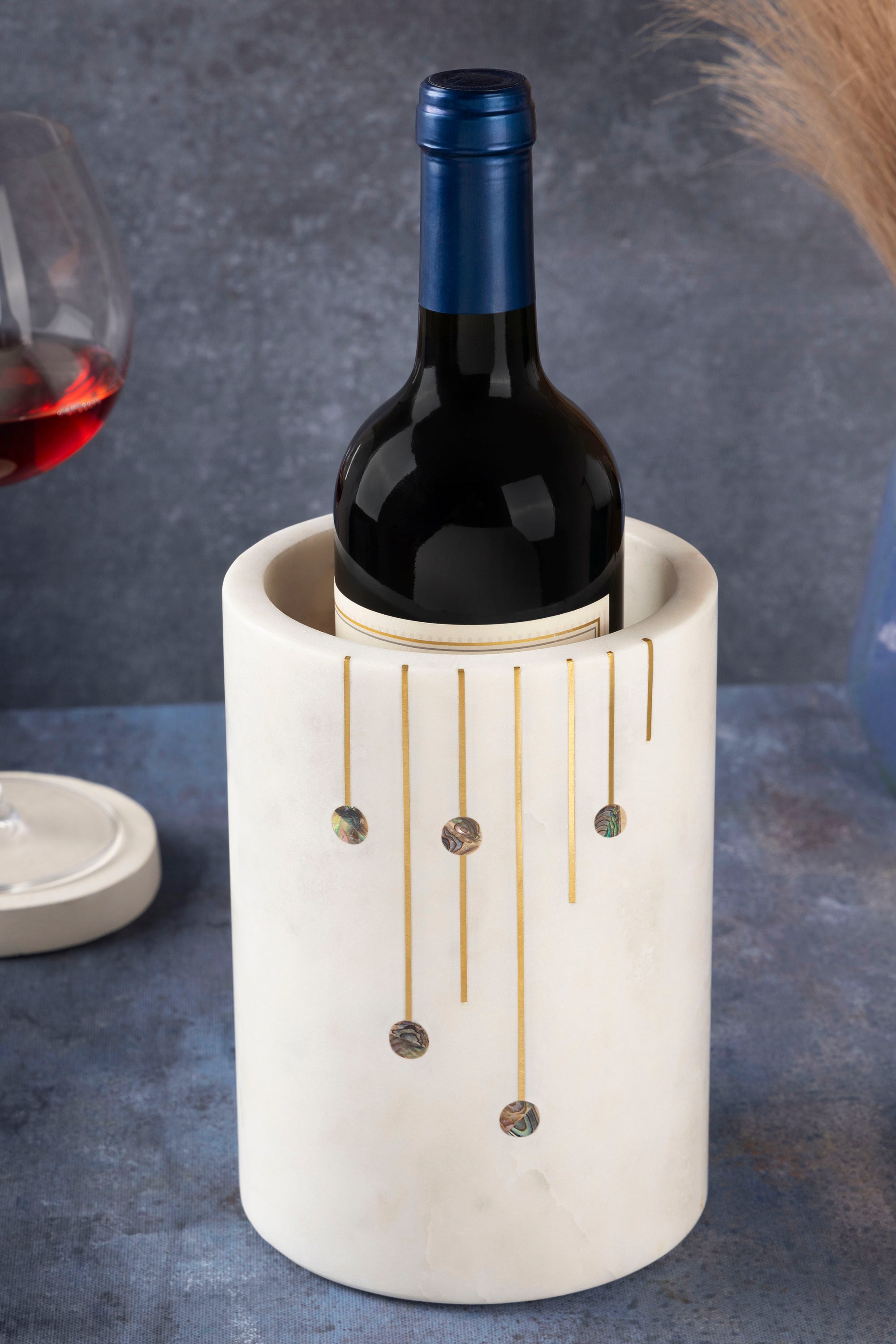 Handcrafted white marble wine cooler with gold and pearl inlay — artisan luxury bar accent