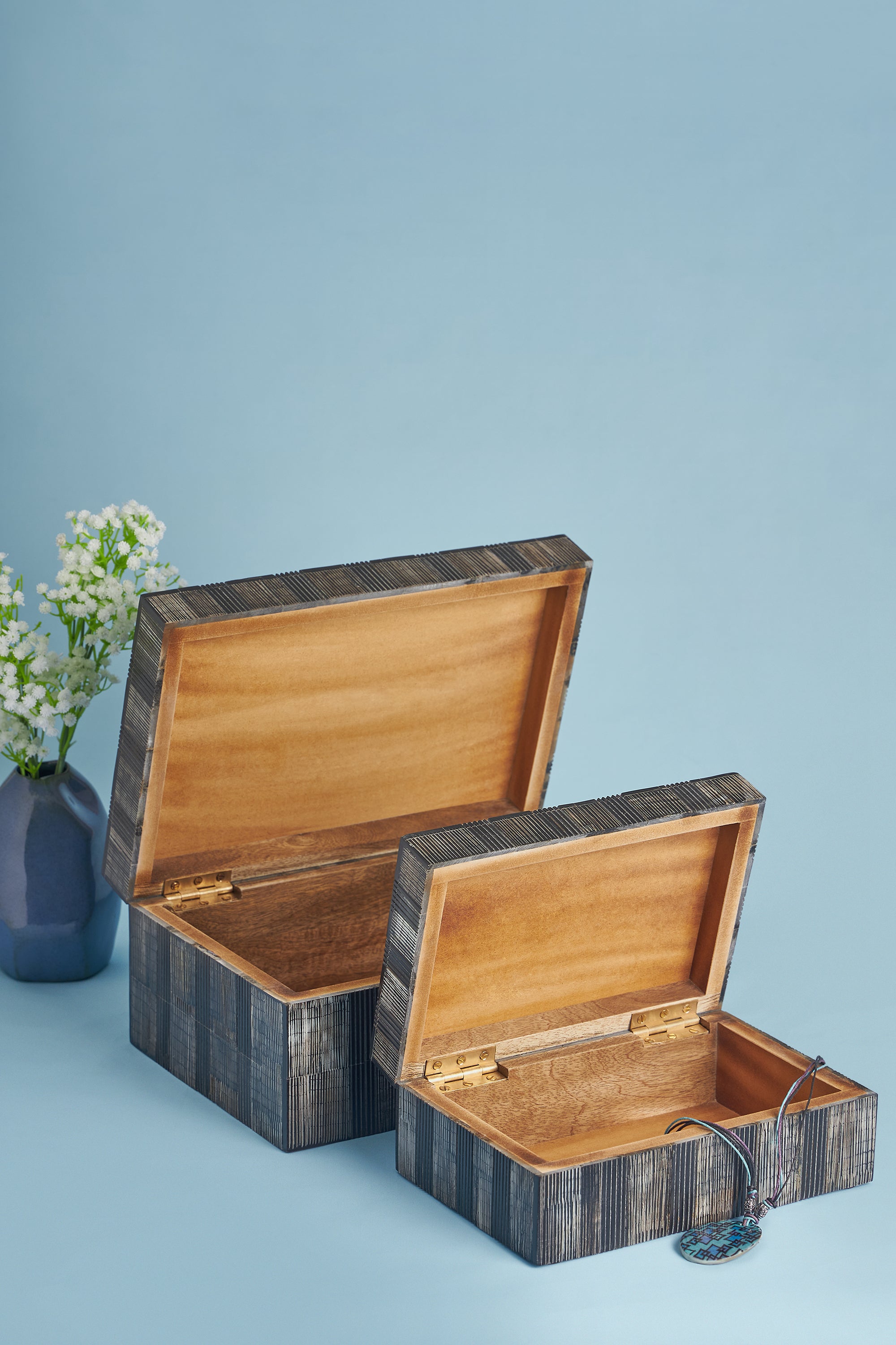 Artisan-made decorative boxes in warm horn tones — luxury tabletop or shelf accessory