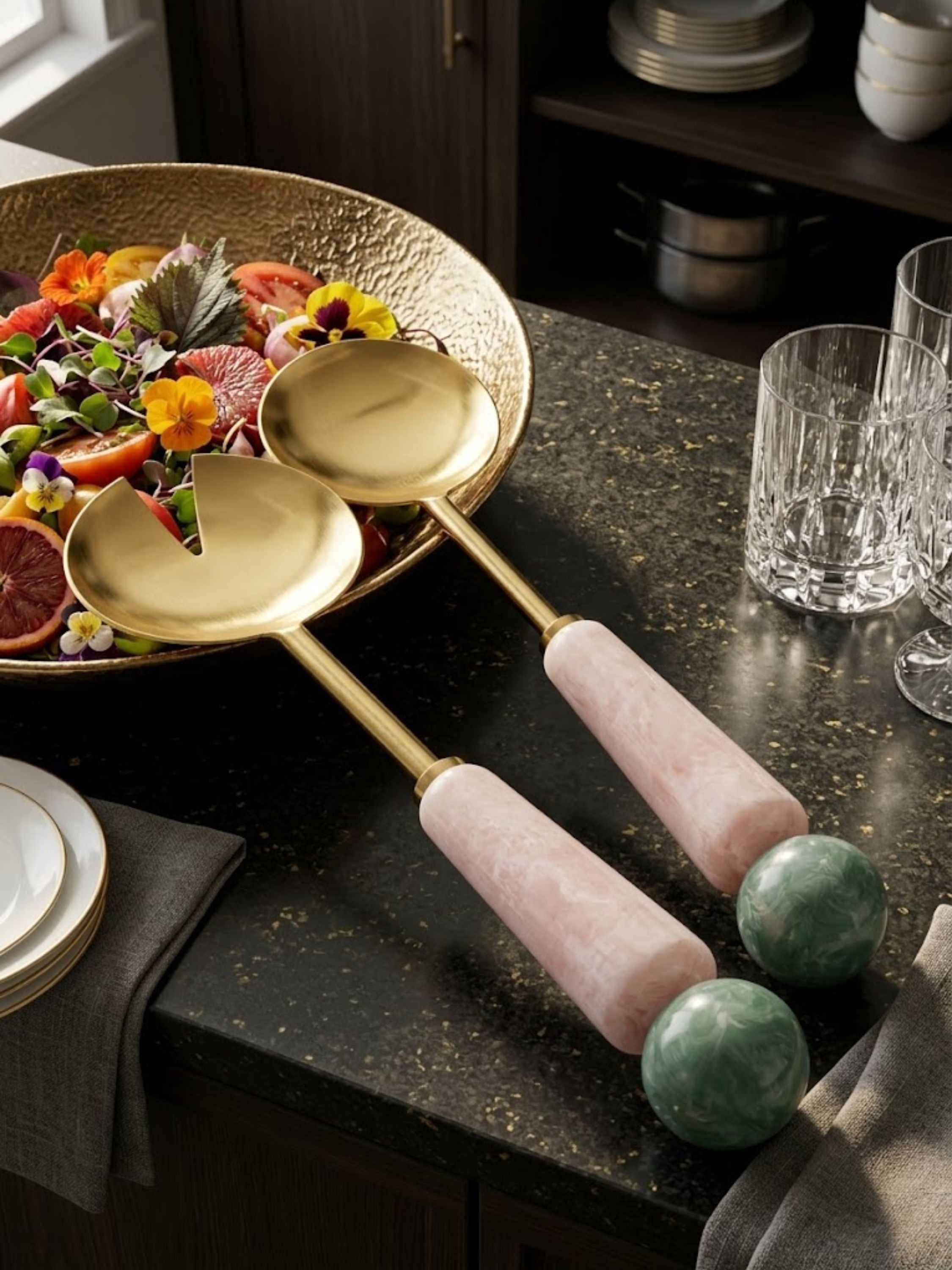 Copenhagen salad serving set displayed with a colorful composed salad, showing its sculptural resin handles and brass heads.