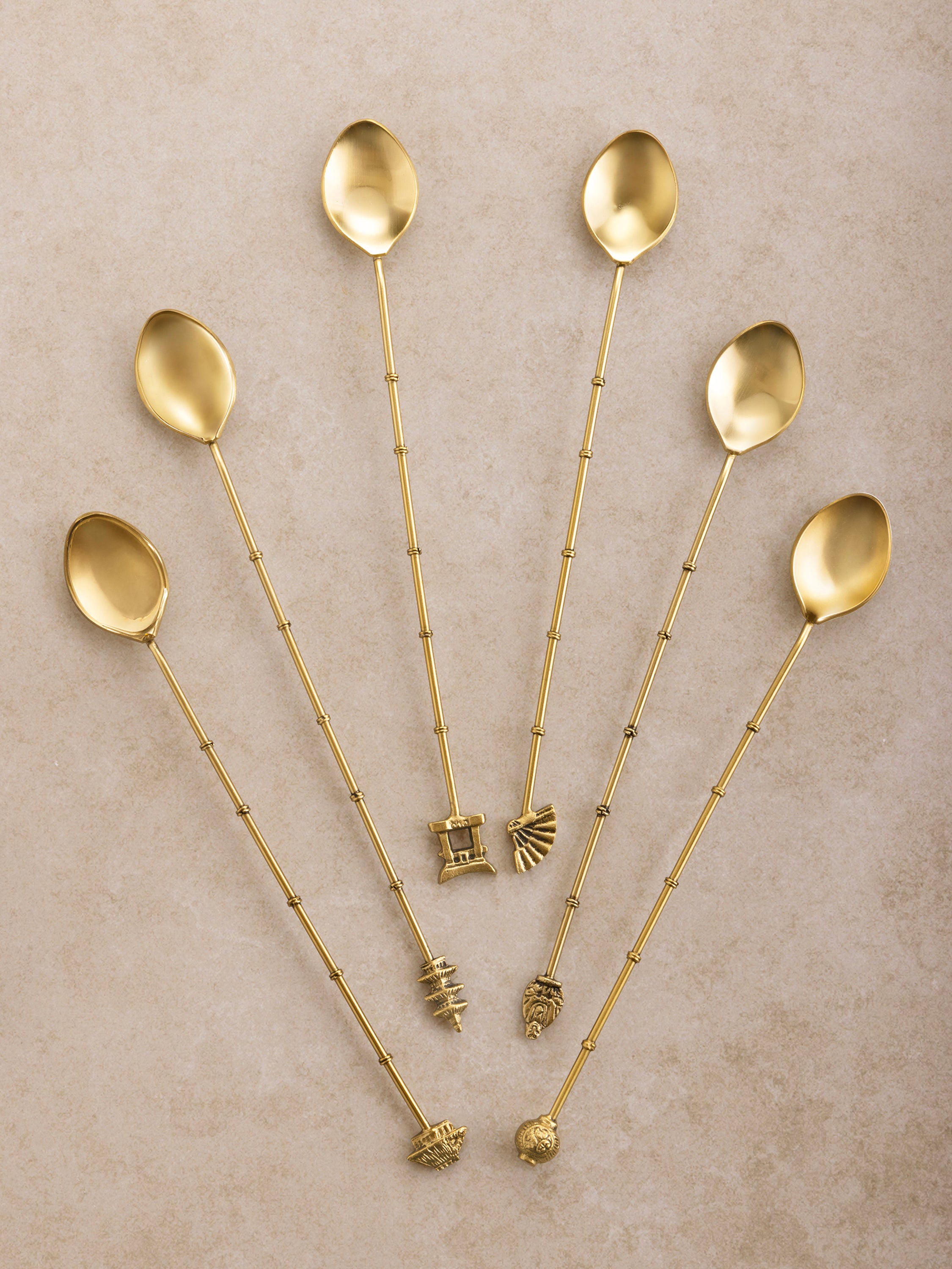 Luxury Gold Cocktail Stirrers - Set of 6: Elegant stainless steel drink stirrers with a gold finish, featuring unique decorative handles inspired by ancient designs. Perfect for upscale cocktail presentations