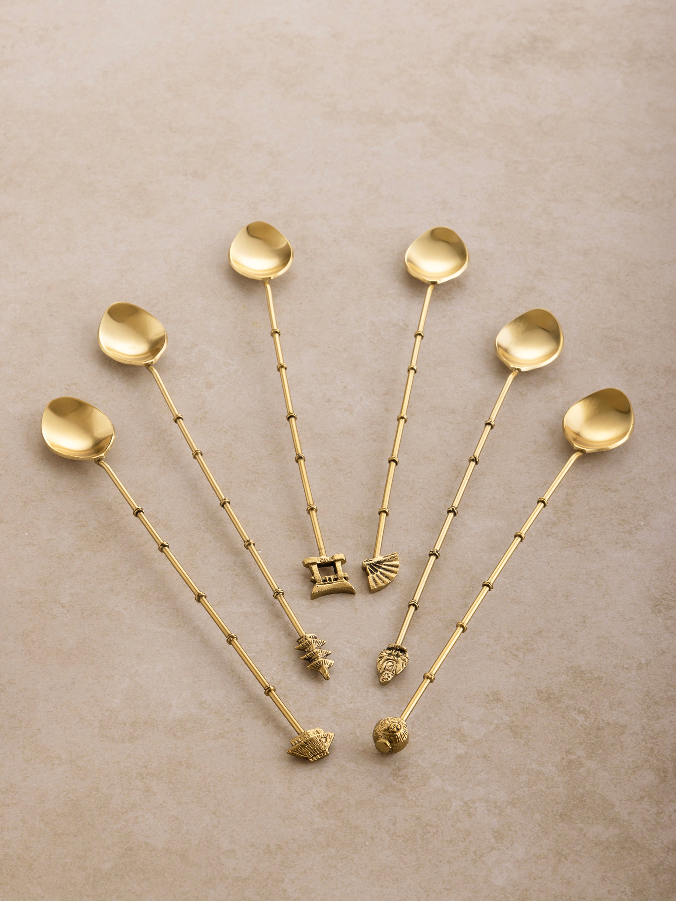 Premium Gold Barware Cocktail Stir Sticks: Set of six gold-finished stainless steel drink stirrers, each featuring a unique sculpted design at the base, adding a sophisticated touch to cocktails