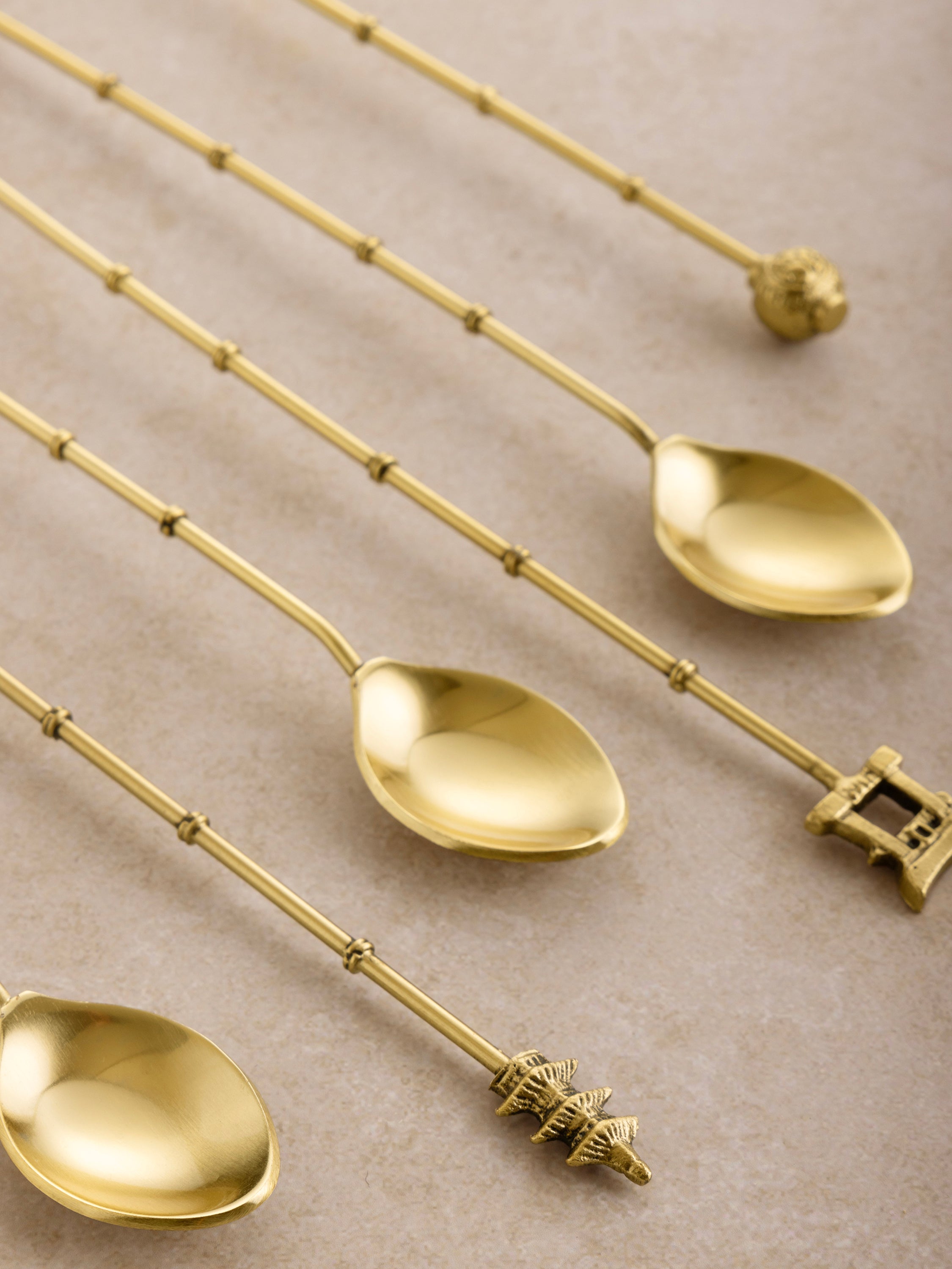 Luxury Gold Drink Stirrers - Bartender Accessories: High-quality stainless steel cocktail stirrers with a stunning gold finish, featuring intricate detailing on the handles, perfect for mixing drinks in style