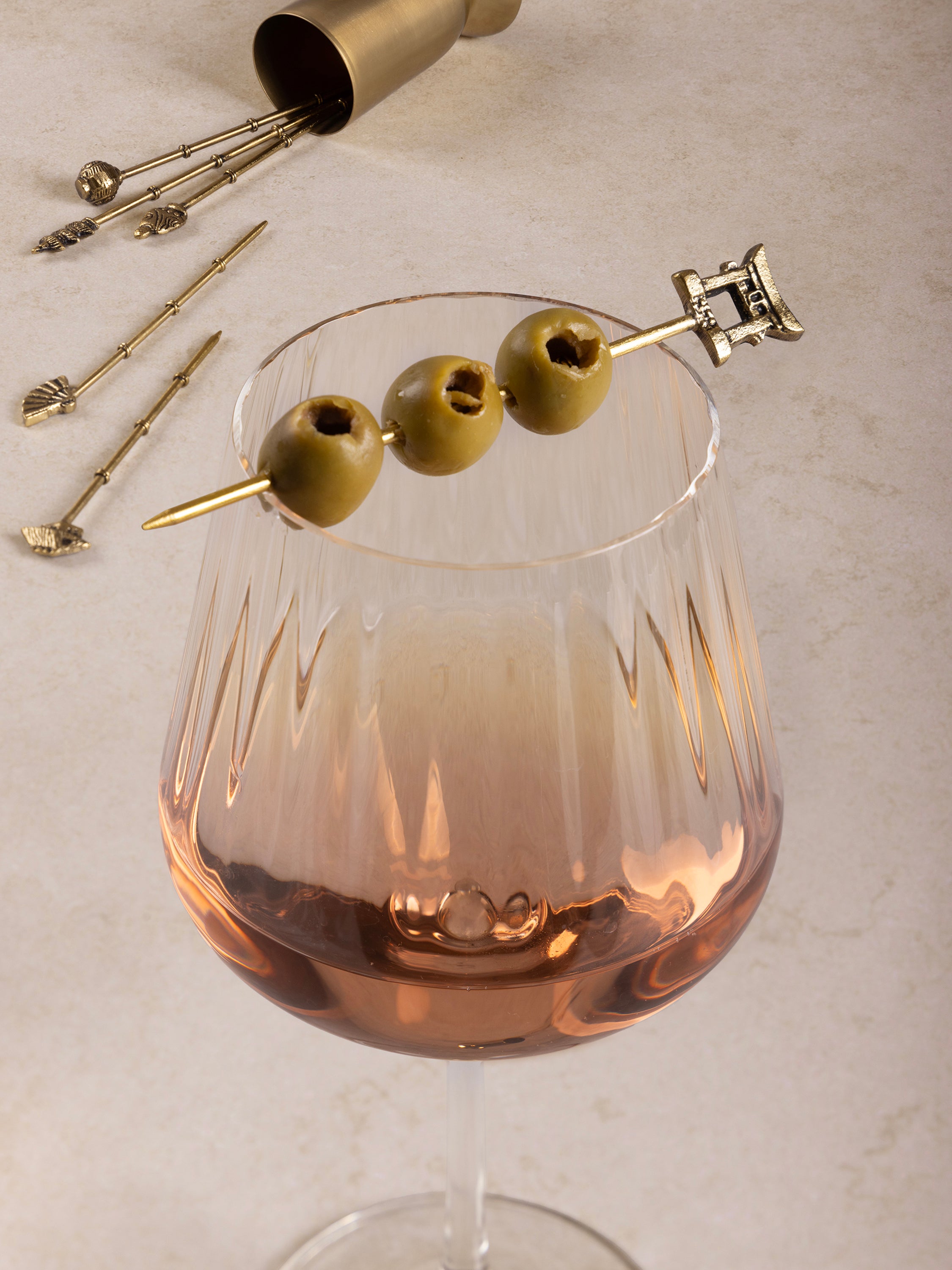 Designer gold cocktail pick set with unique handcrafted decorative tops