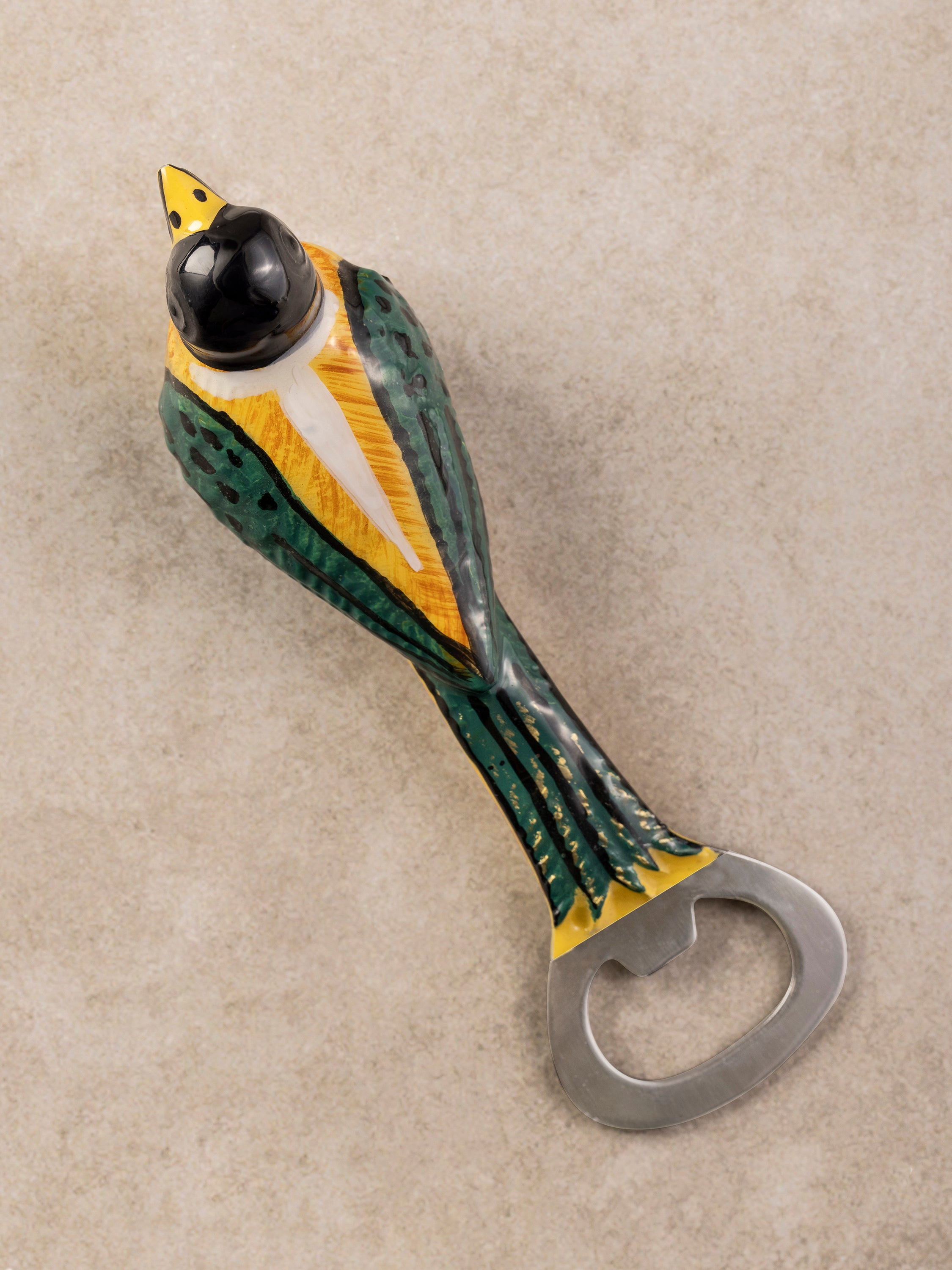 Close-up of the Magpie bottle opener showing detailed feather texture and a smooth polished finish along the body.