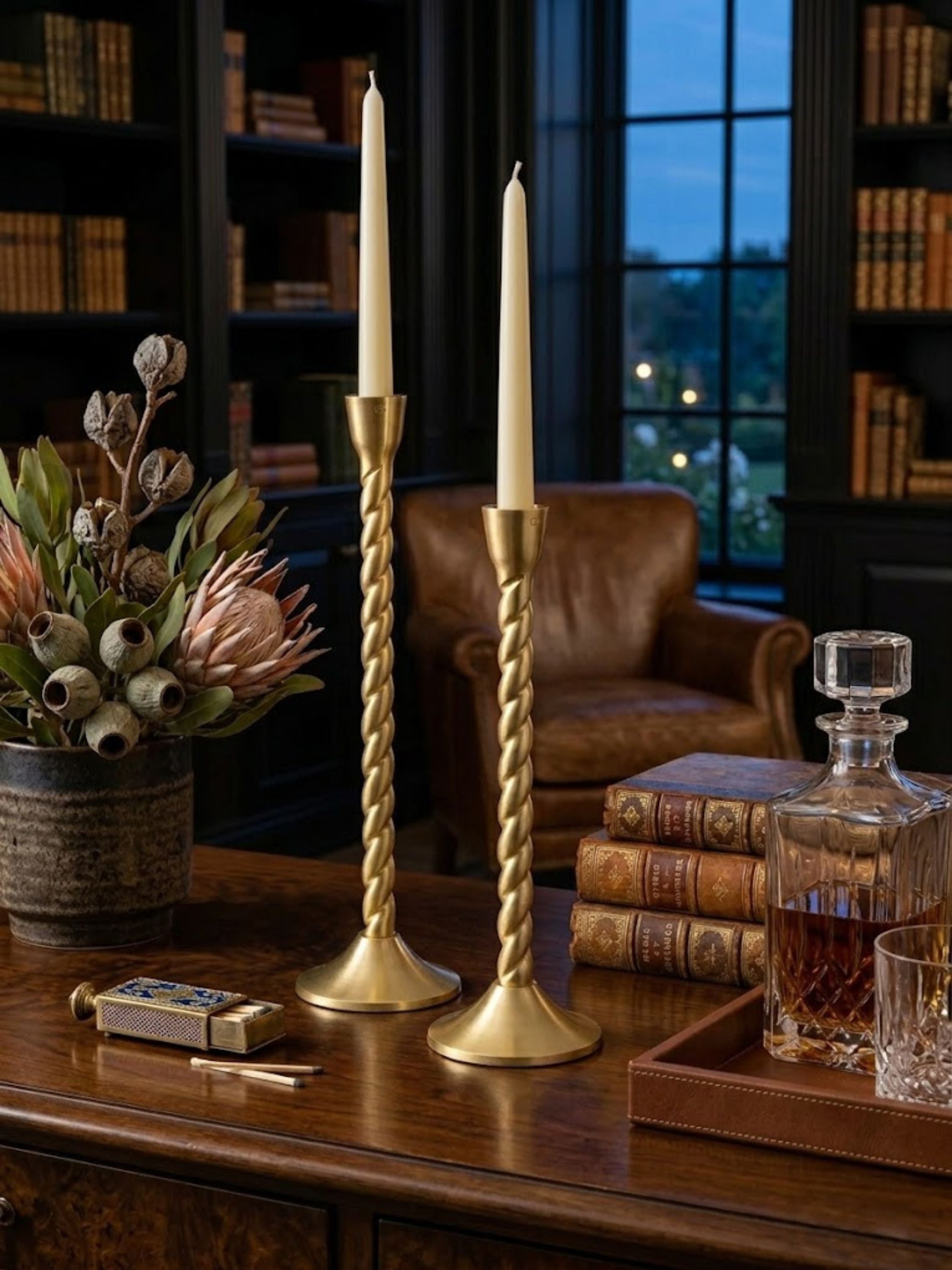 Twilight gold candle holders styled on a marble fireplace mantel, showcasing graceful twisted silhouettes that add warm ambient light.