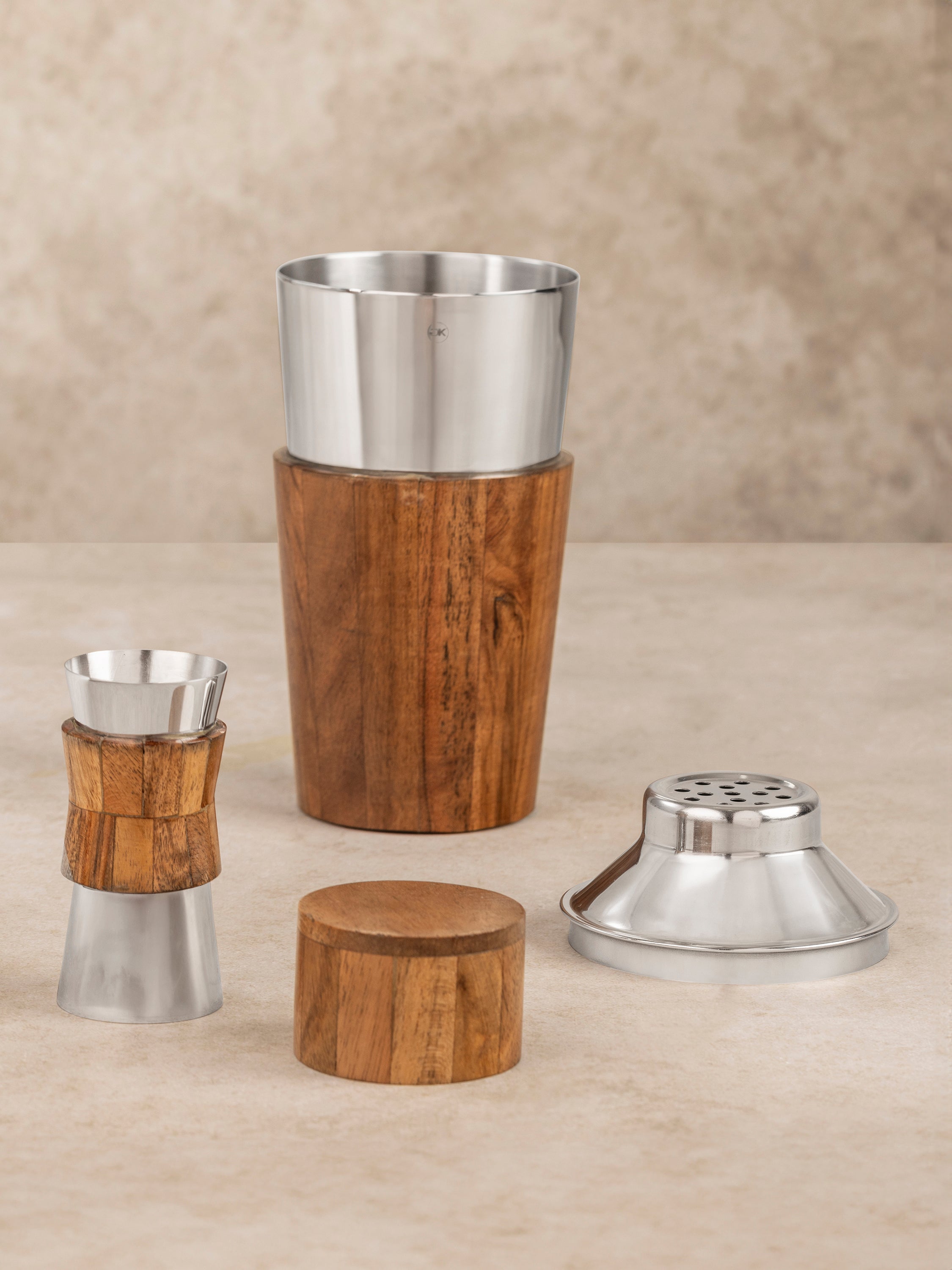 Chicago cocktail set components arranged together showing stainless steel shaker, wood inlay lid, and matching jigger