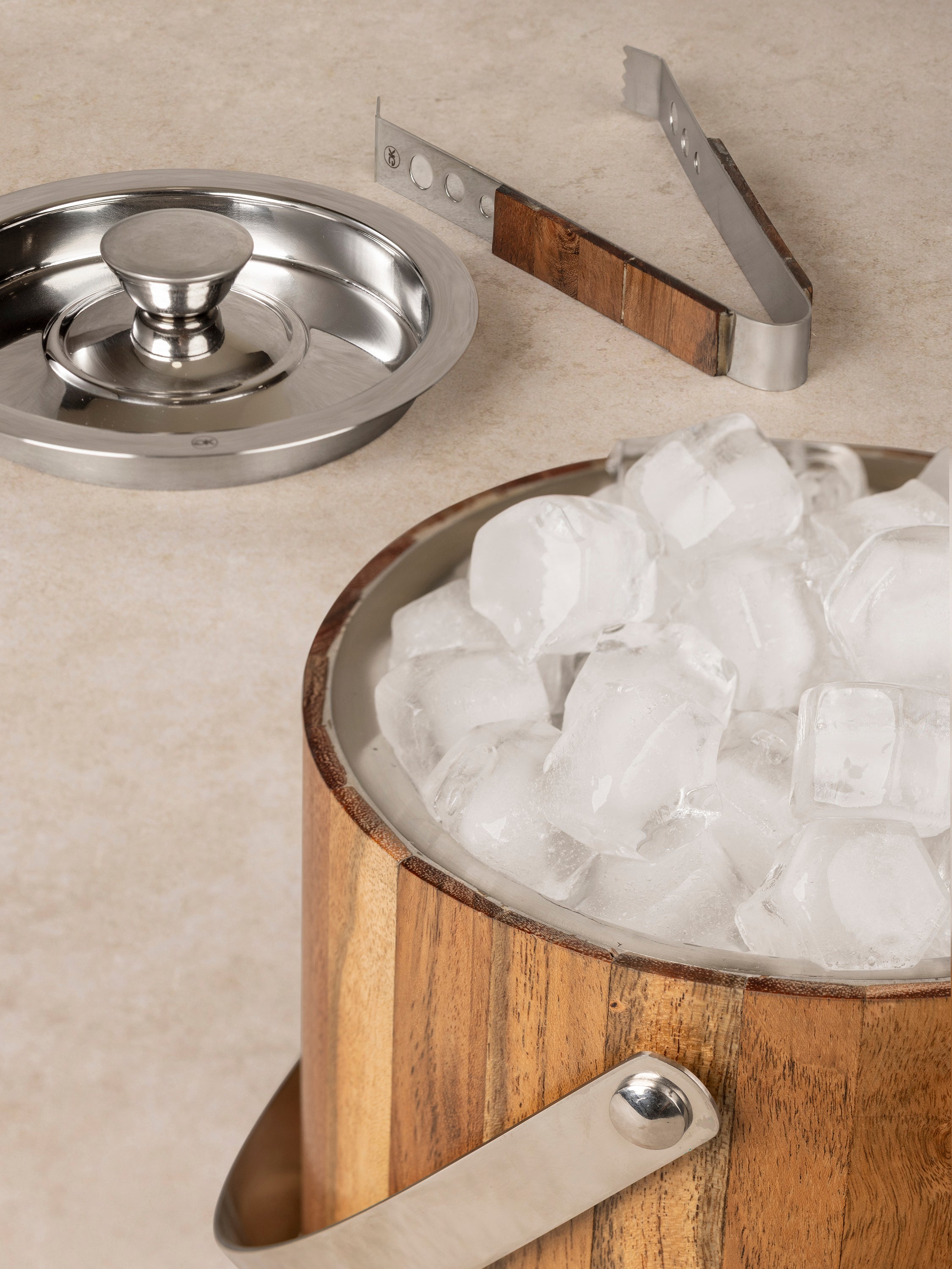 Close-up of Chicago ice bucket showing wood exterior grain, stainless steel rim, and fitted lid detail
