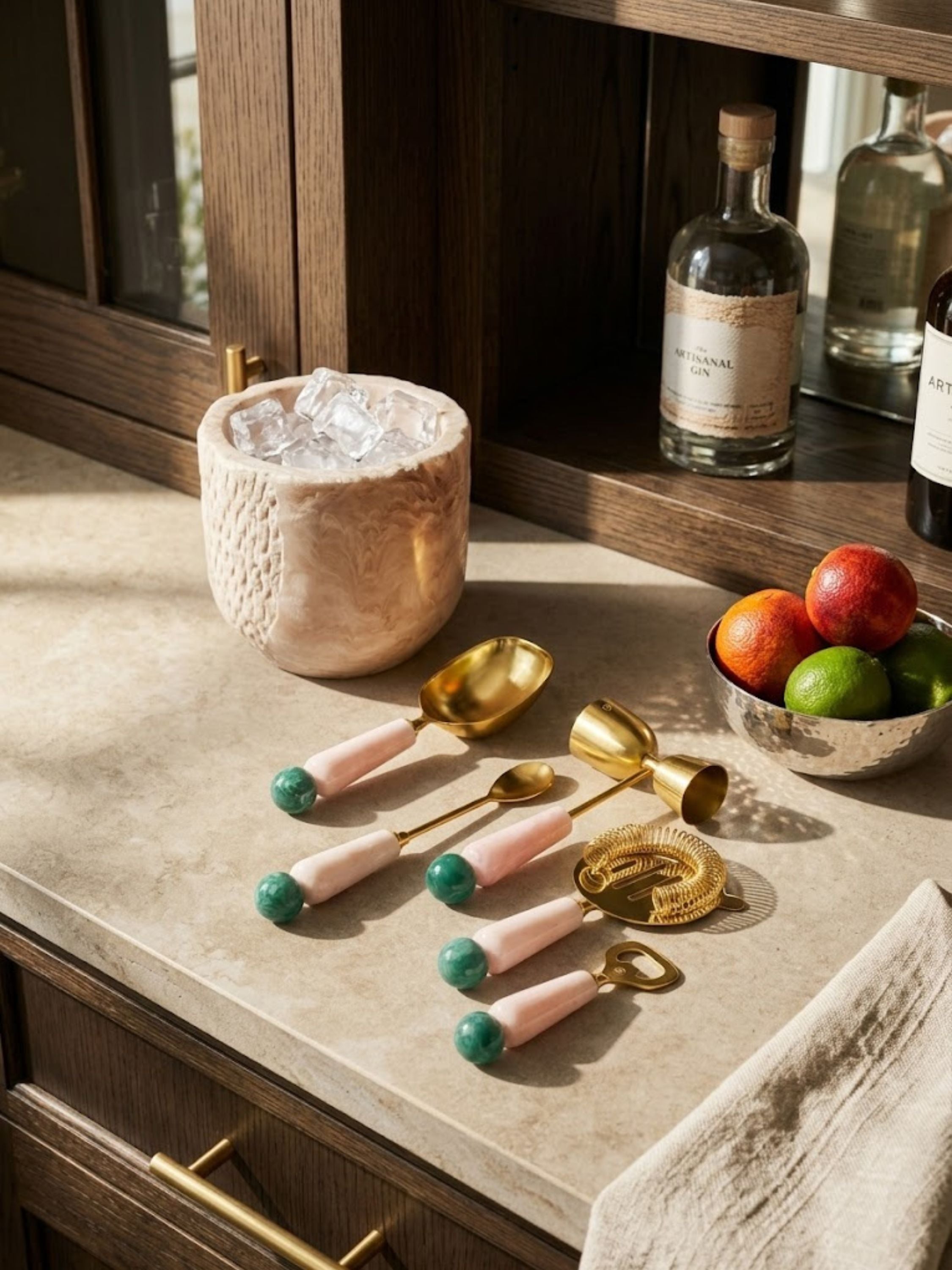 Copenhagen resin bar tools displayed on a home bar countertop with citrus garnishes and an ice bucket, highlighting elevated cocktail preparation and serving.