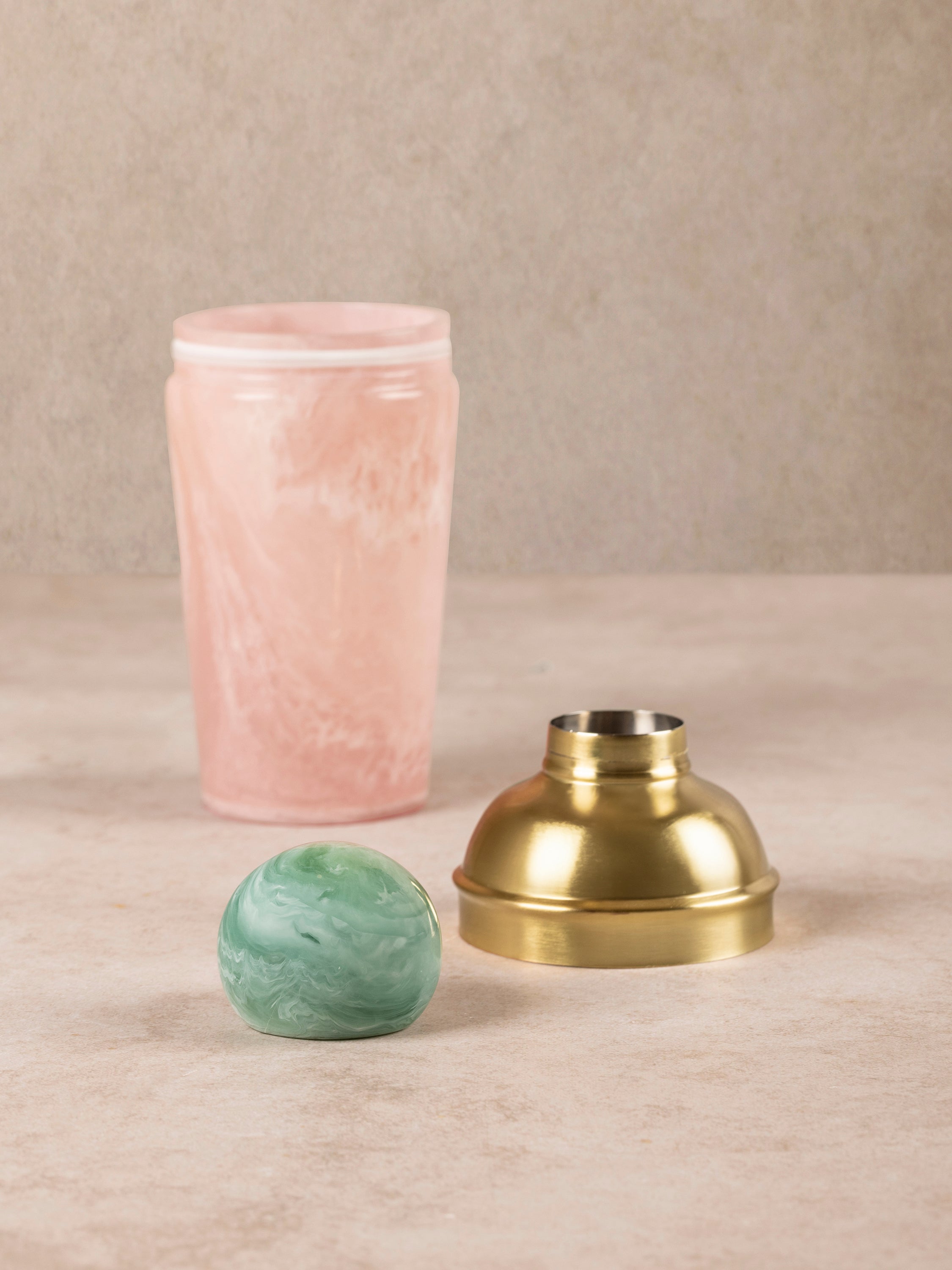 Copenhagen cocktail shaker components arranged showing shaker body, strainer lid, and green knob in detail