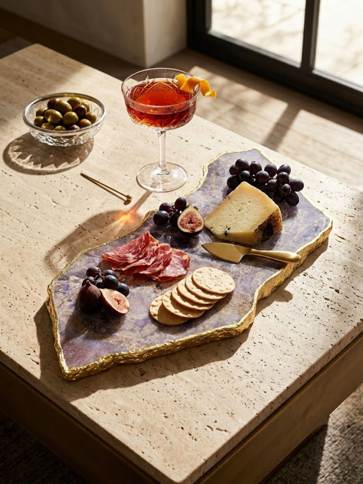 Amethyst stone cheese board with a freeform edge, styled on a dining table.